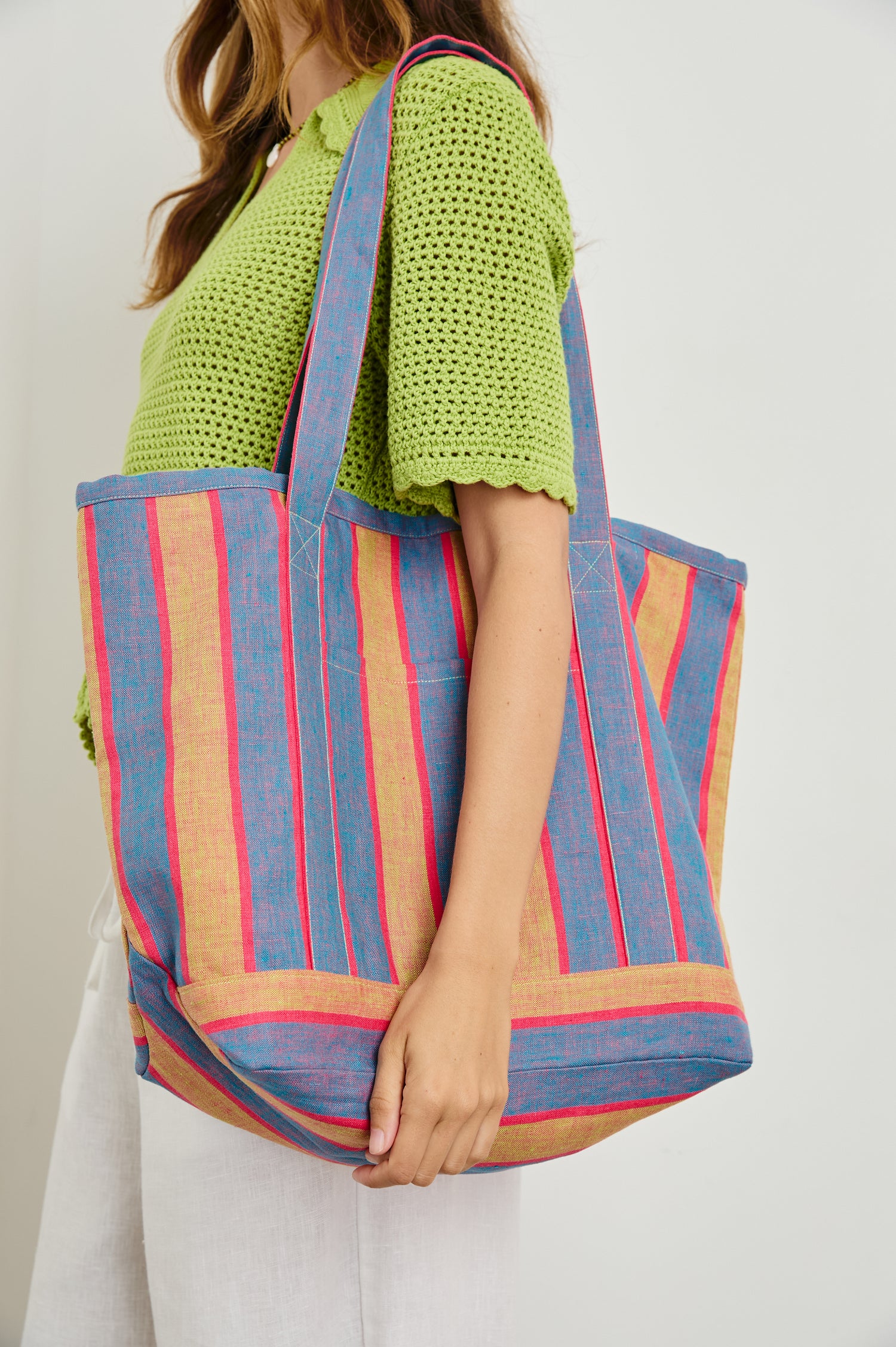 Striped linen Beach Tote with front pocket and long, wide shoulder straps in Rio Stripe - close up of bag, model carrying over shoulder