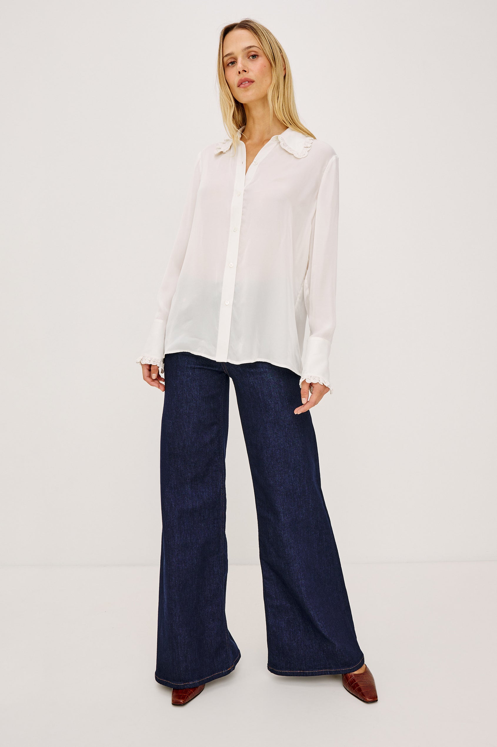 Beatrix Shirt in Smooth Cupro With Point Collar, Eyelet Ruffle Trim, Relaxed Fit, and Long Sleeves in Ivory Colorway - Full Body Front View Featured on Model
