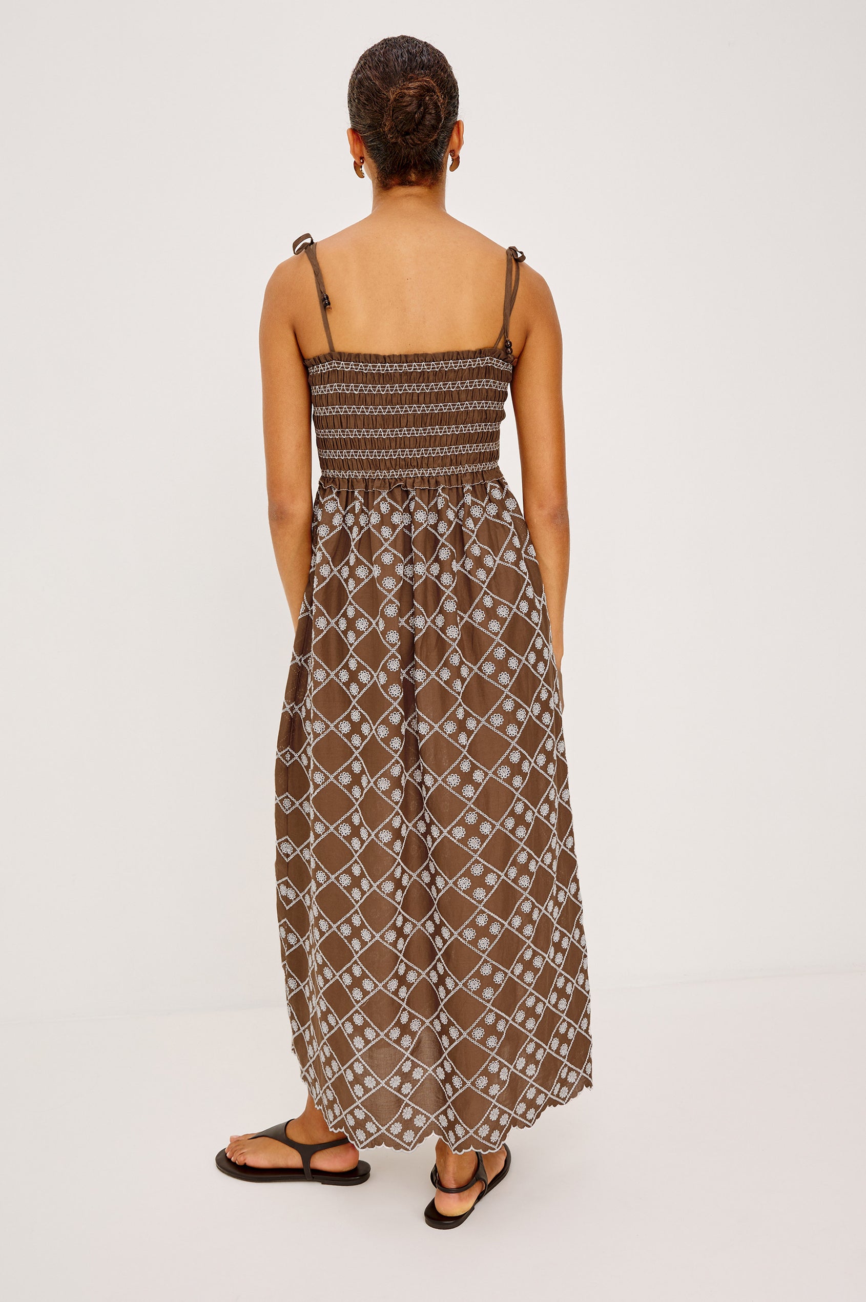 Becca Maxi Dresss in Cotton Voile Wih Beaded Adjustable Shoulder Ties, Straight Neckline, Smocked Bodice, Empire Waist, and Full Skirt in Cocoa Daisy Embroidery - Back View Featured on Model