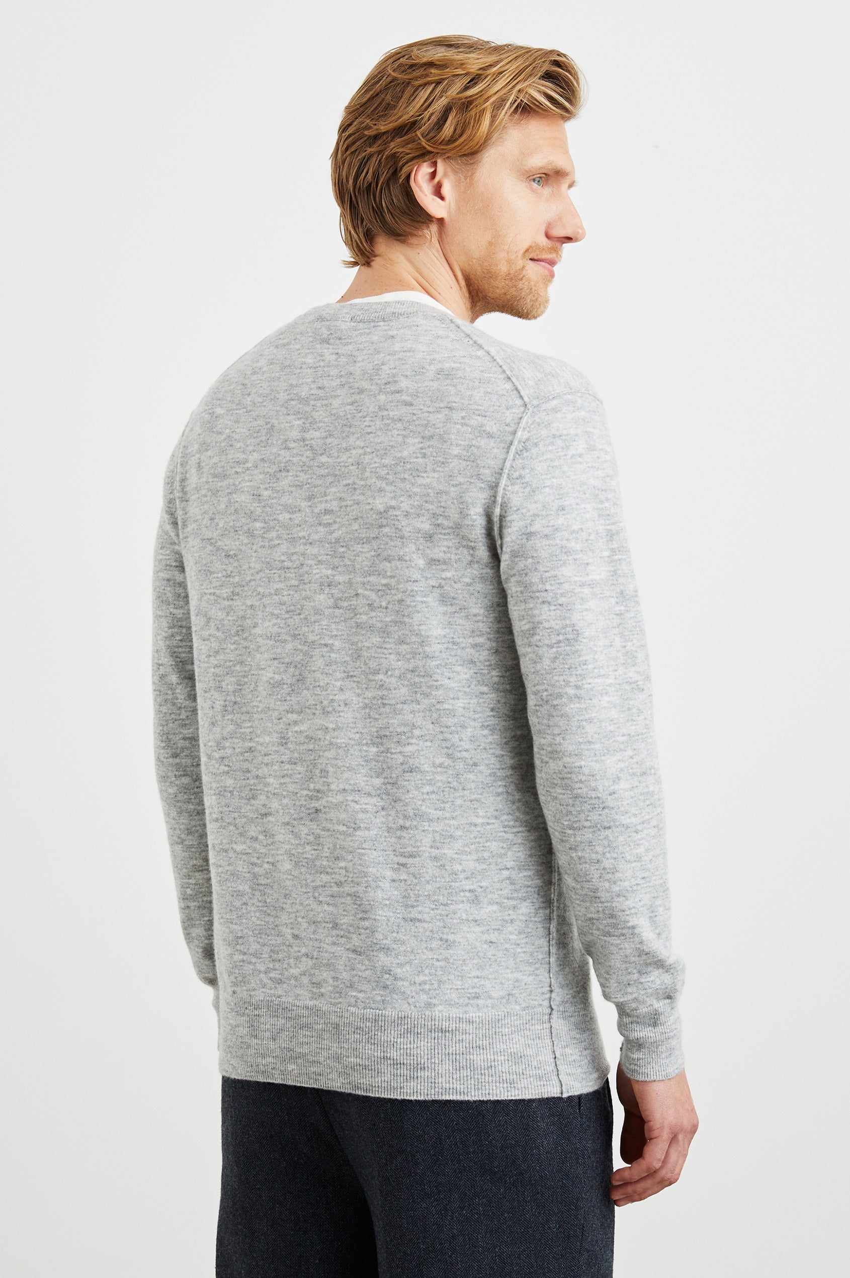 Beckson Long-Sleeve Sweater with a Crew Neck, and Raw Edges at Seams in Heather Grey Colorway - Back View Featured on Model 