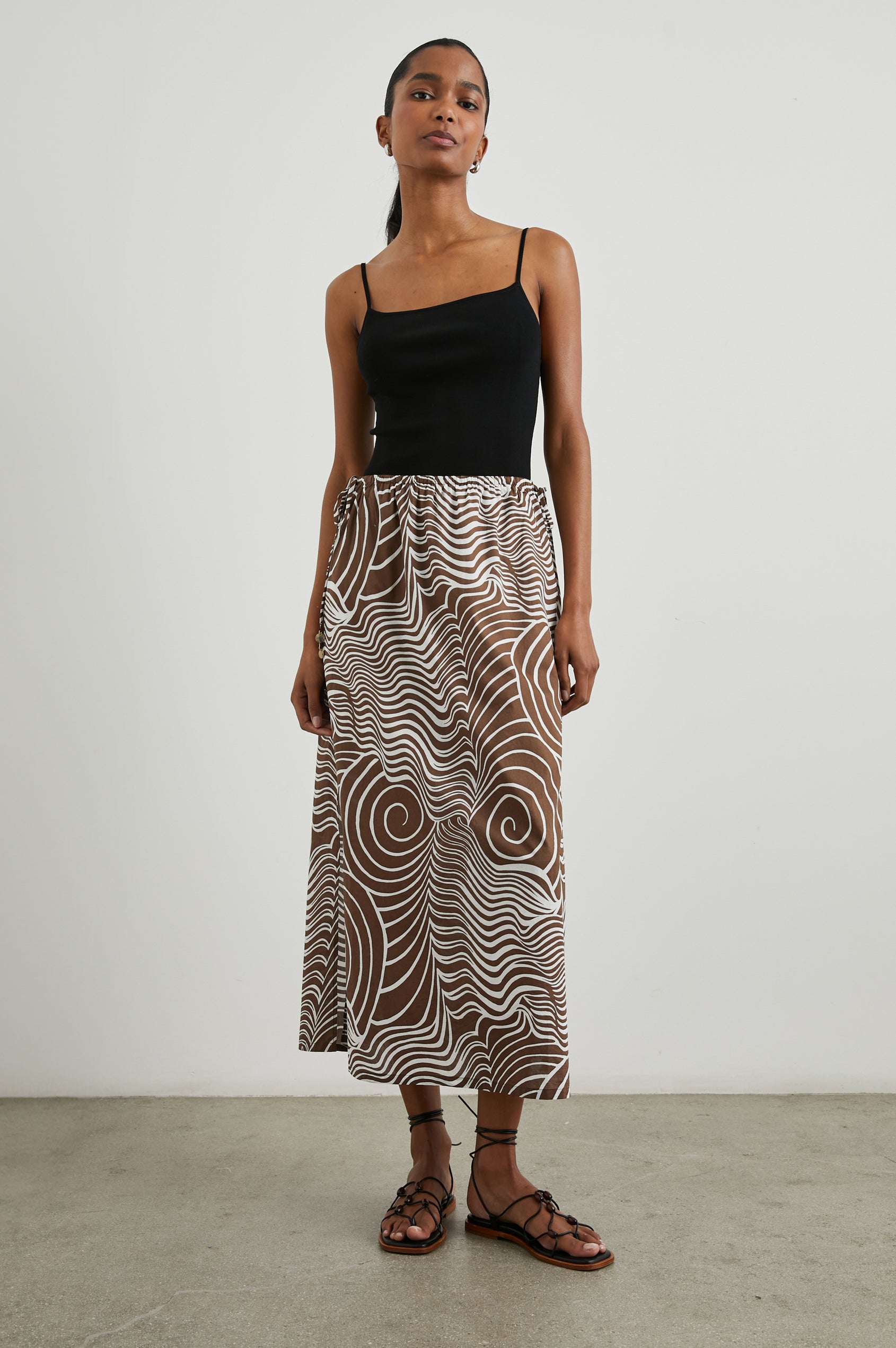 Beech Midi Skirt with a Side Drawstring Waist in Swirls Colorway, White Waves and Swirls on Brown - Front Full Body View Featured on Model 