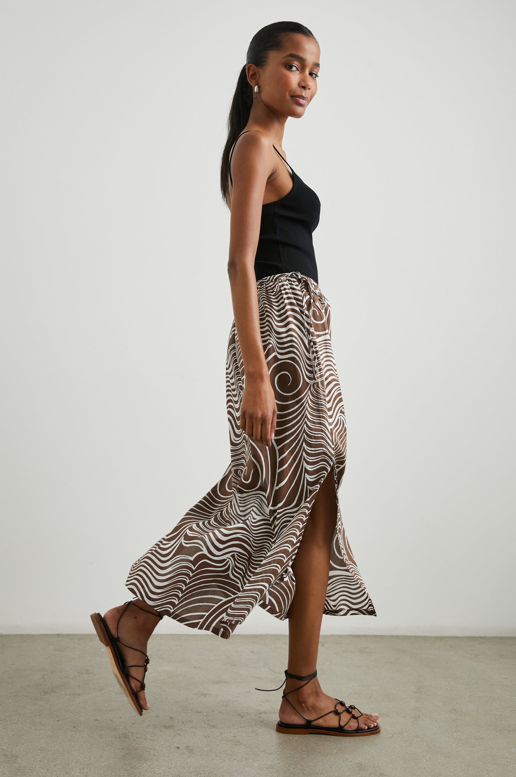 Beech Midi Skirt with a Side Drawstring Waist in Swirls Colorway, White Waves and Swirls on Brown - Side Full Body View Featured on Model 