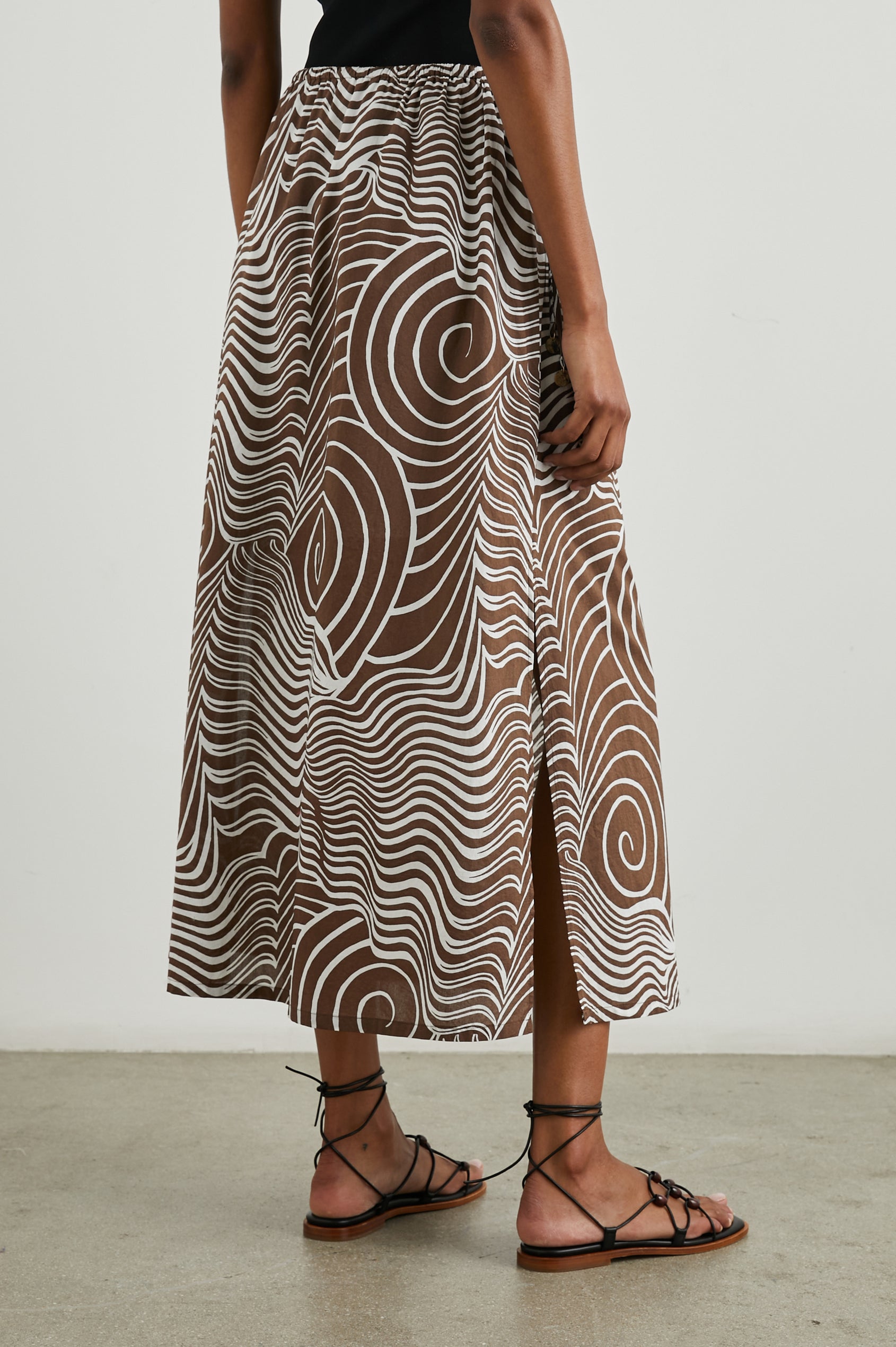 Beech Midi Skirt with a Side Drawstring Waist in Swirls Colorway, White Waves and Swirls on Brown - Back View Featured on Model 