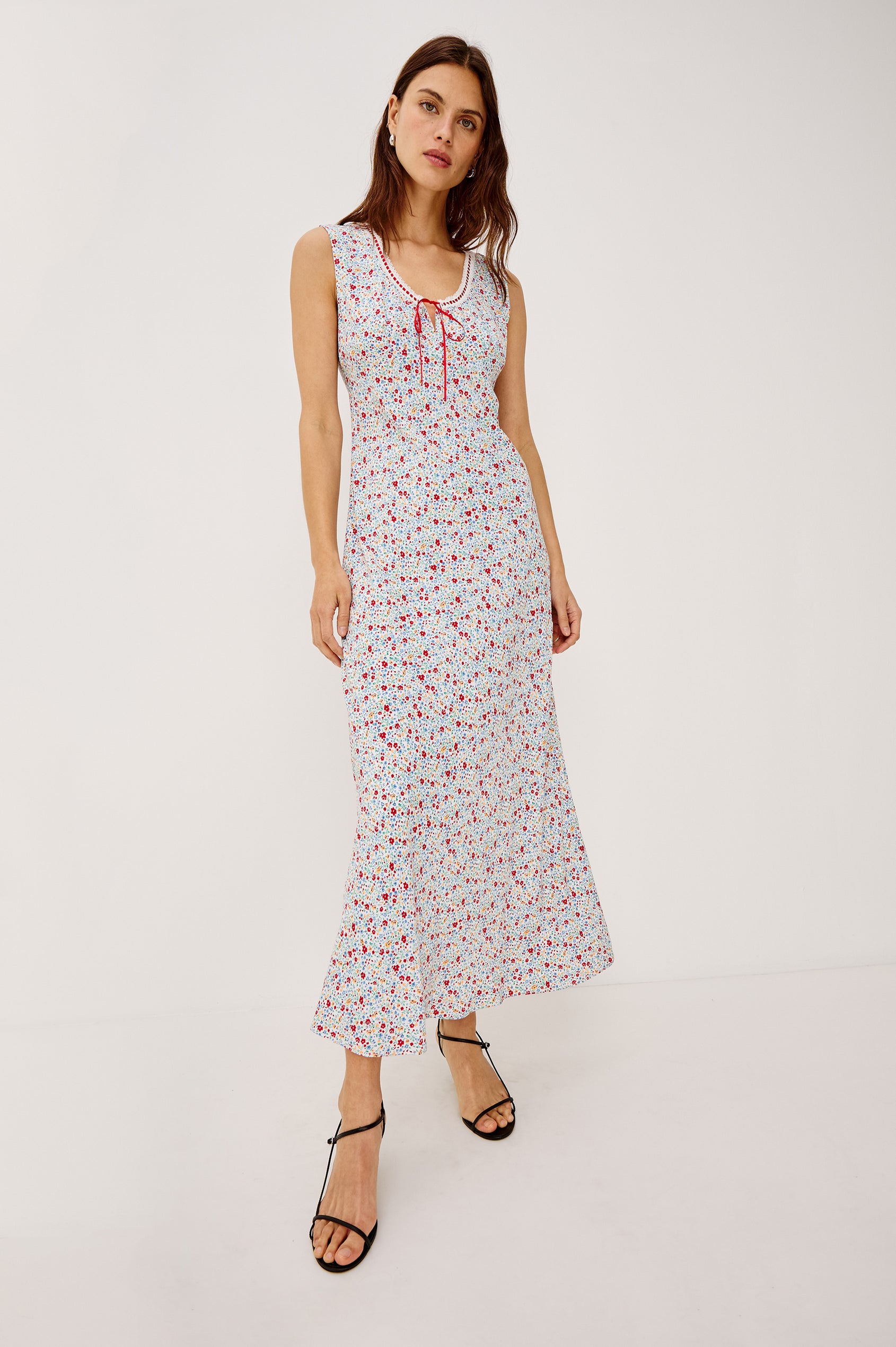 Bella sleeveless midi dress, with a scoop neck, and a front tie detail in meadow colorway, blue, pink and white - full body front view show on model.