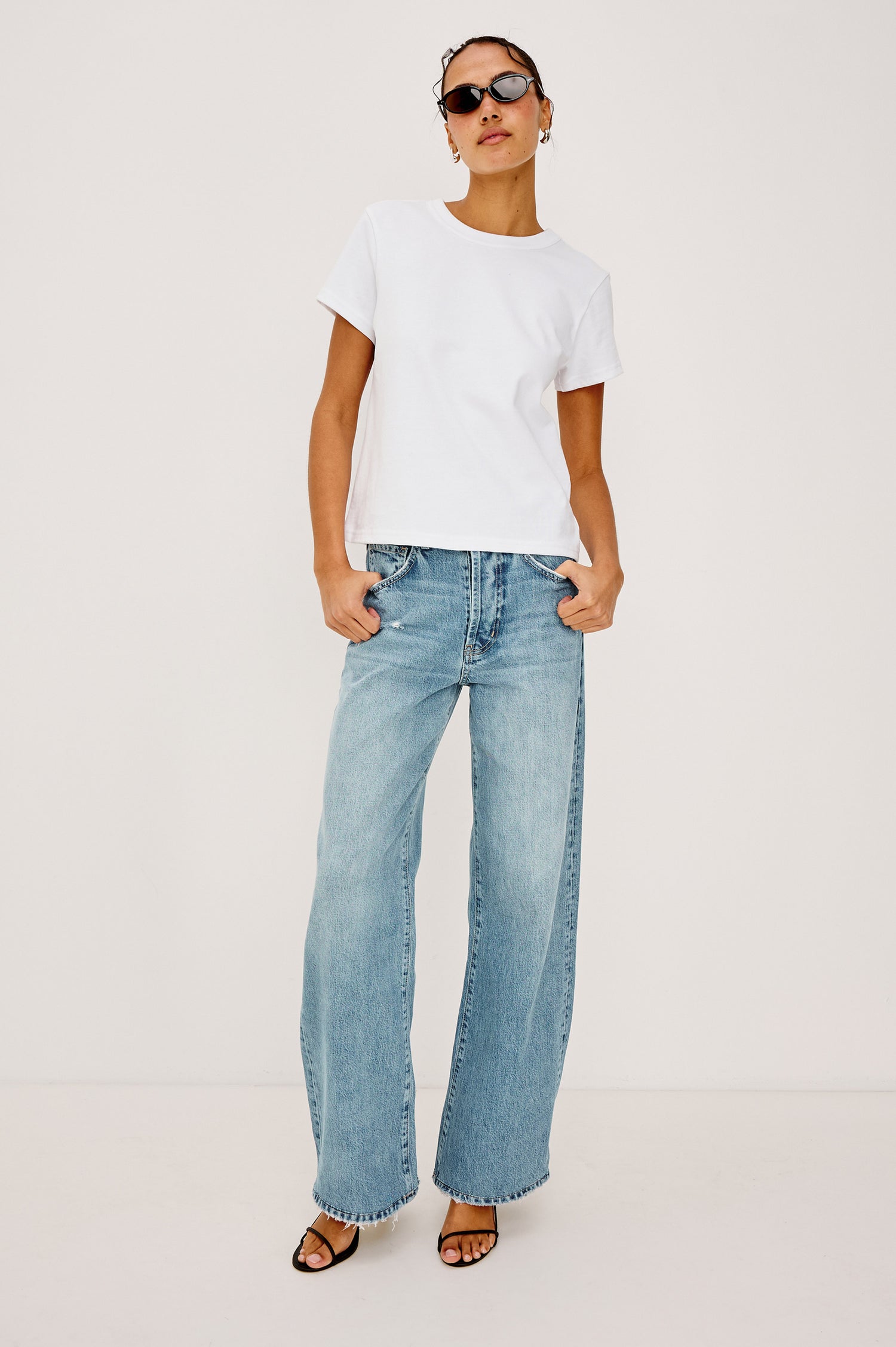 Belmont Arc Leg Jean in Rigid Denim With High-Waisted Fit, Button Fly, and 32″ Inseam in Ecru Railroad Stripe Colorway - Lower Body Back View Featured on Model