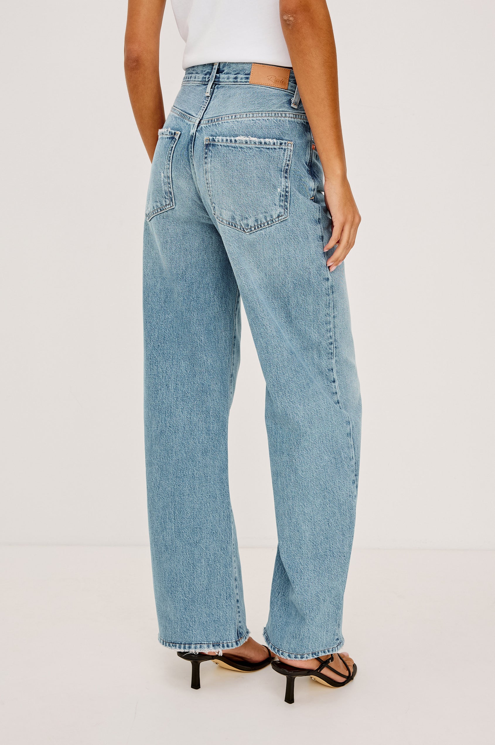 Belmont Arc Leg Jean in Rigid Denim With High-Waisted Fit, Button Fly, and 32″ Inseam in Authentic Stone Colorway - Lower Body Back View Featured on Model