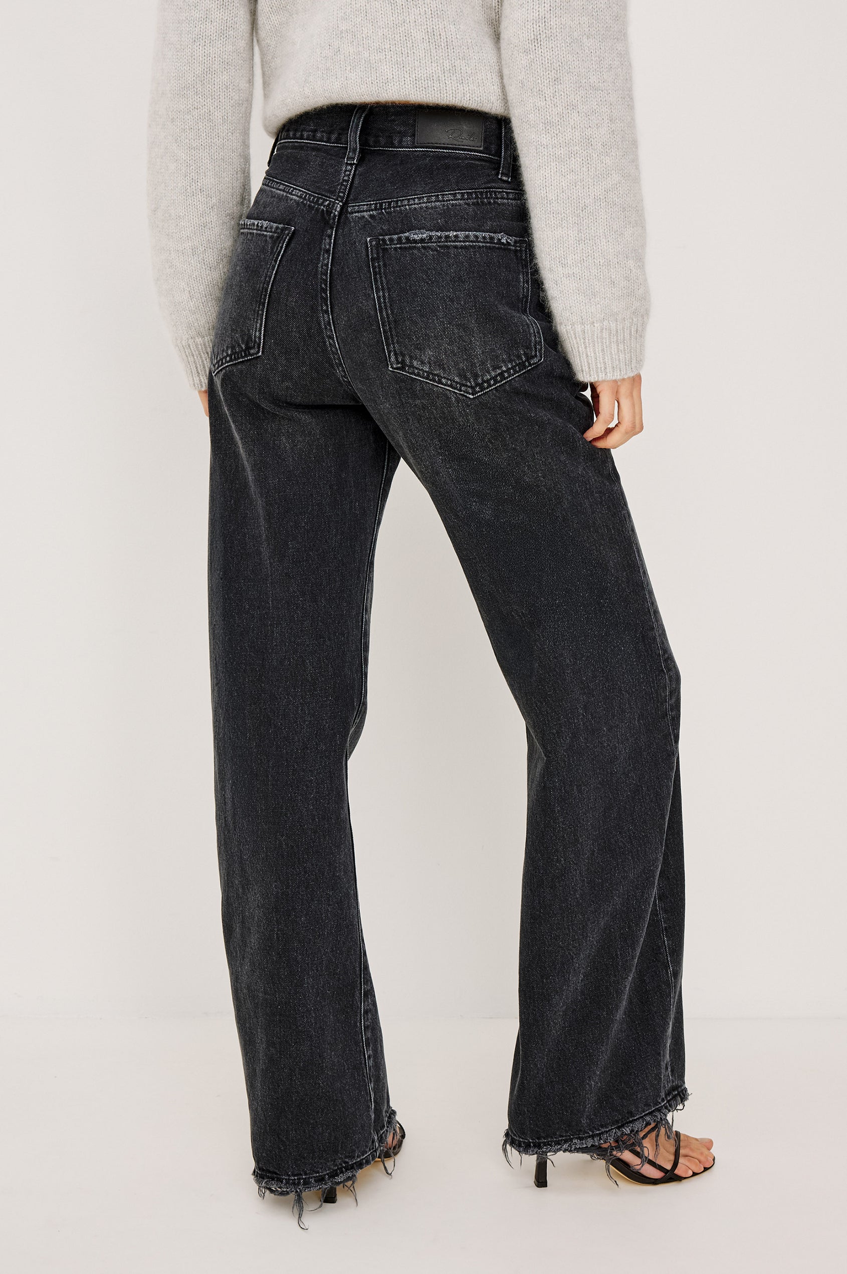 Belmont Arc Leg Jean in Rigid Denim With High Rise, Distressed Detailing, Button Fly, and 5-Pockets in Night Cap Colorway - Lower Body Back View Featured on Model