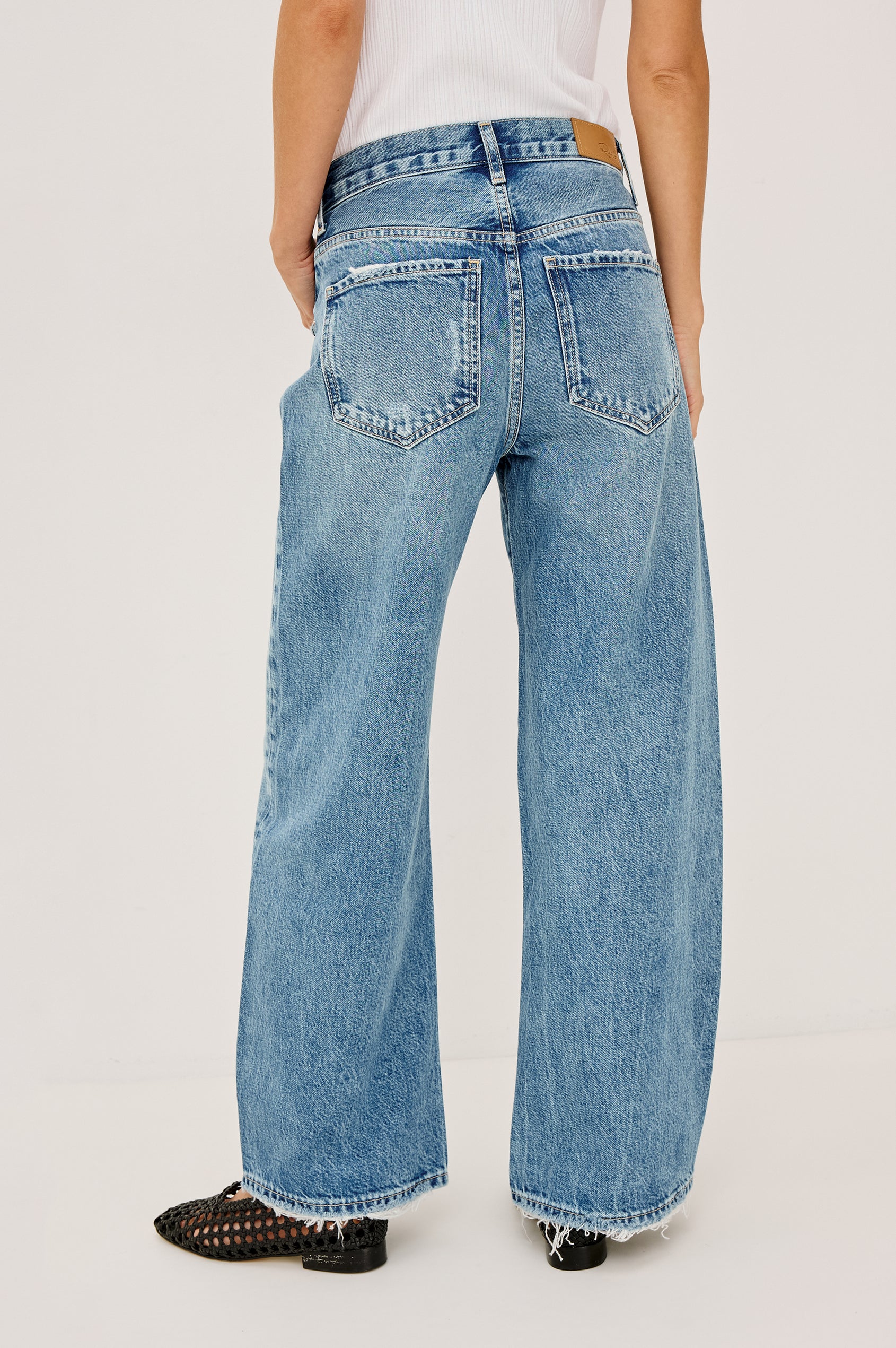 Belmont Arc Leg Jean in Rigid Denim With High-Waisted Fit, Button Fly in Authentic Stone Colorway - Back View Featured on Model