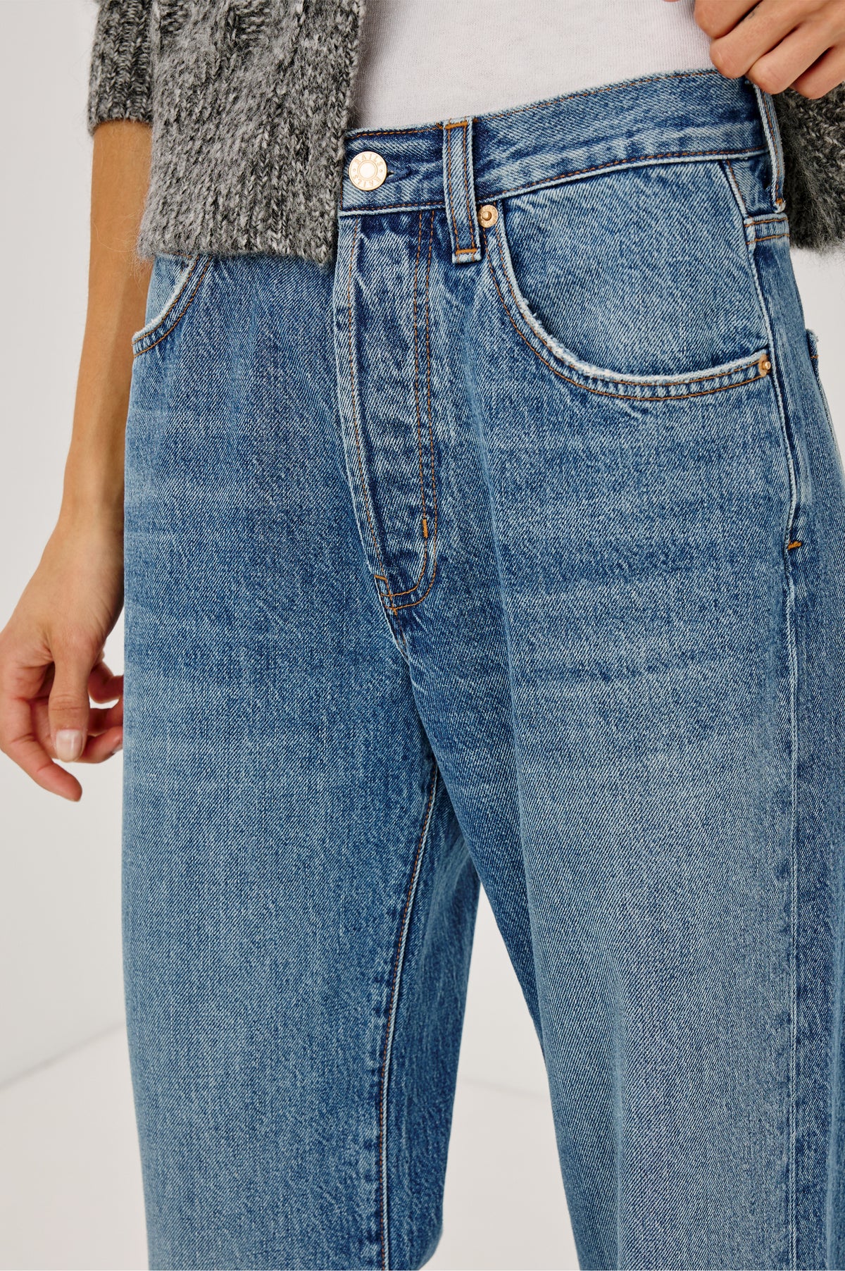 Petite Belmont Arc Leg Jean in Rigid Denim With High Rise, Distressed Detailing, Button Fly, and 5-Pockets in Homestead Colorway - Close up view featured on model