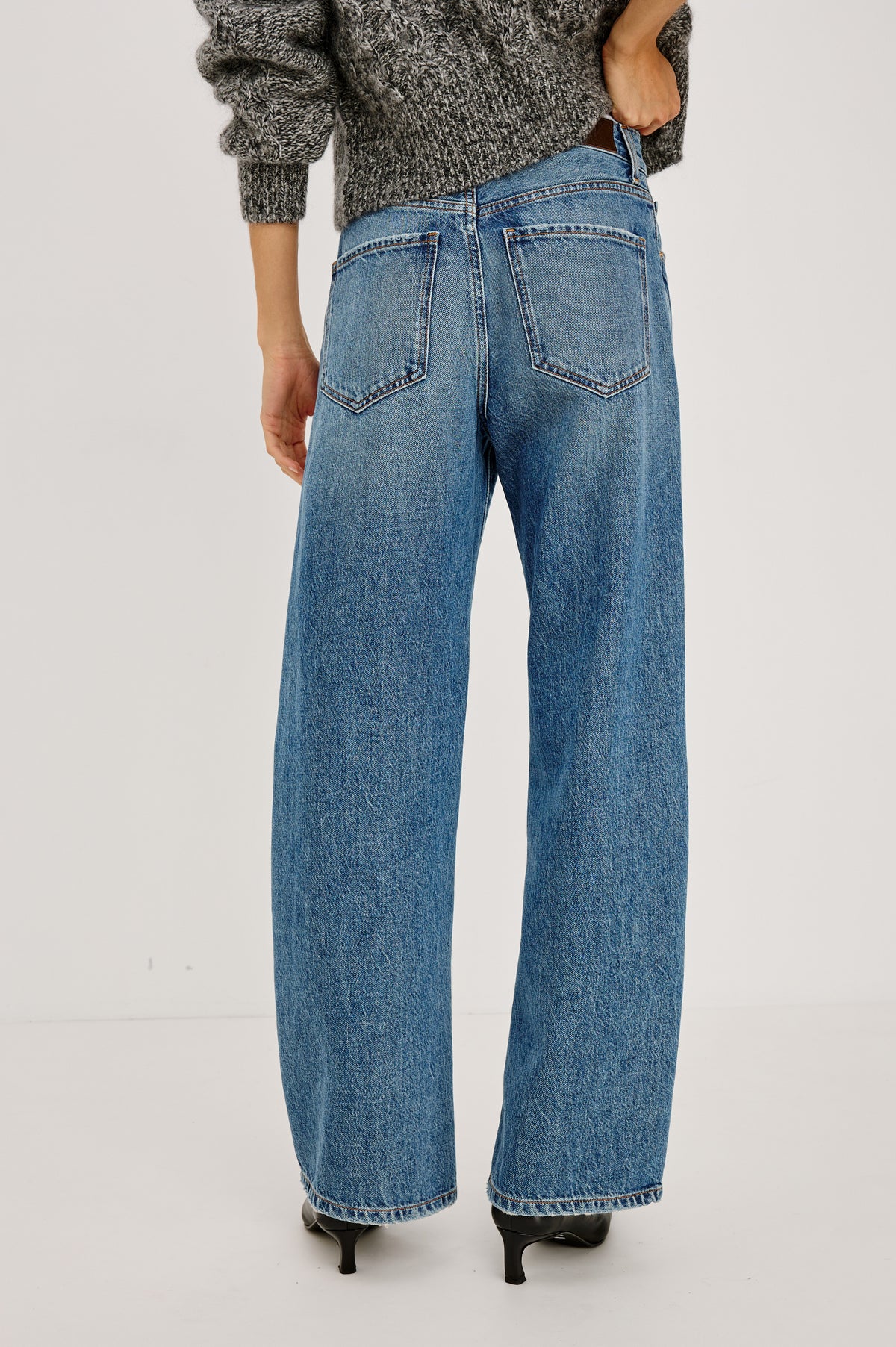 Petite Belmont Arc Leg Jean in Rigid Denim With High Rise, Distressed Detailing, Button Fly, and 5-Pockets in Homestead Colorway - Back View Featured on Model