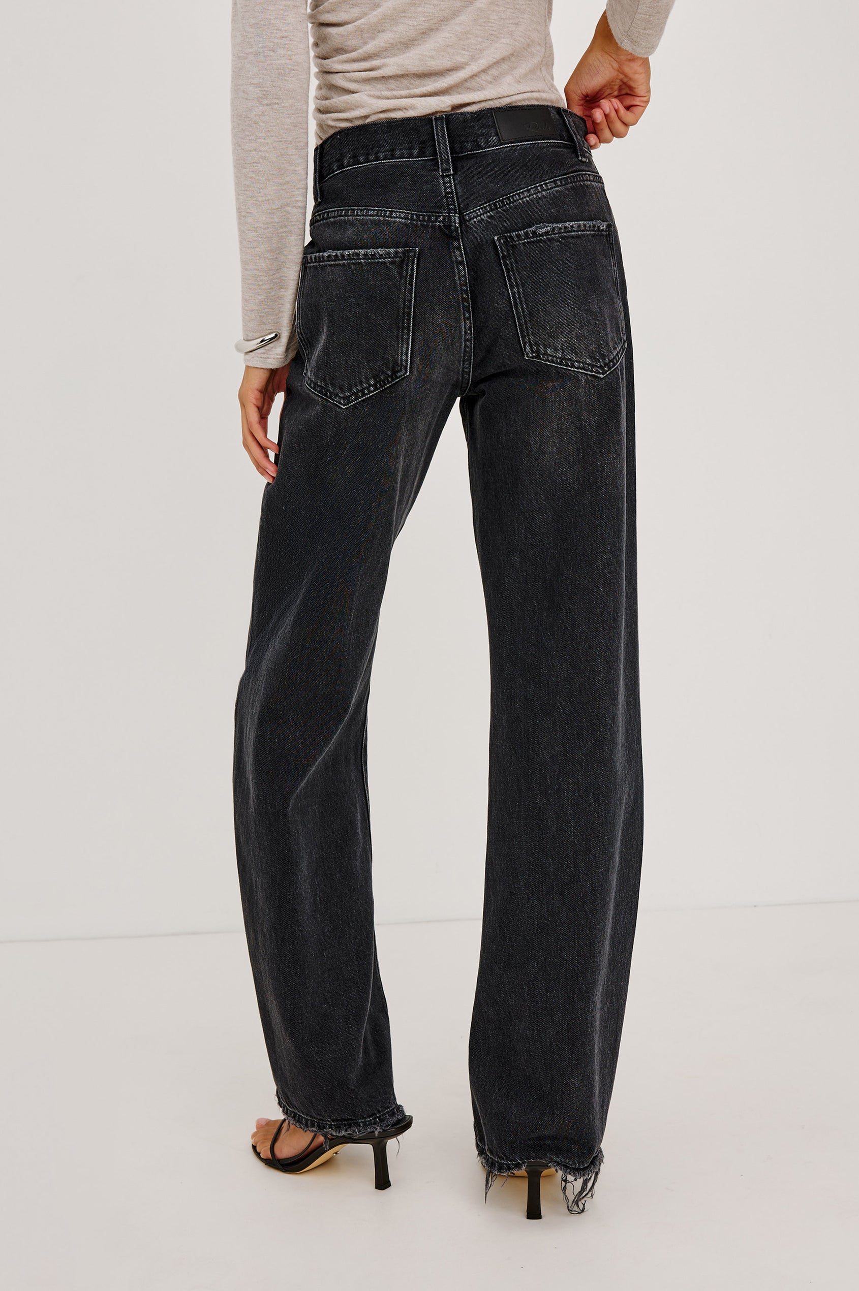 Belmont Petite Arc Leg Jean in Rigid Denim With High Rise, Distressed Detailing, Button Fly, and 5-Pockets in Nightcap Colorway - Lower Body Back View Featured on Model