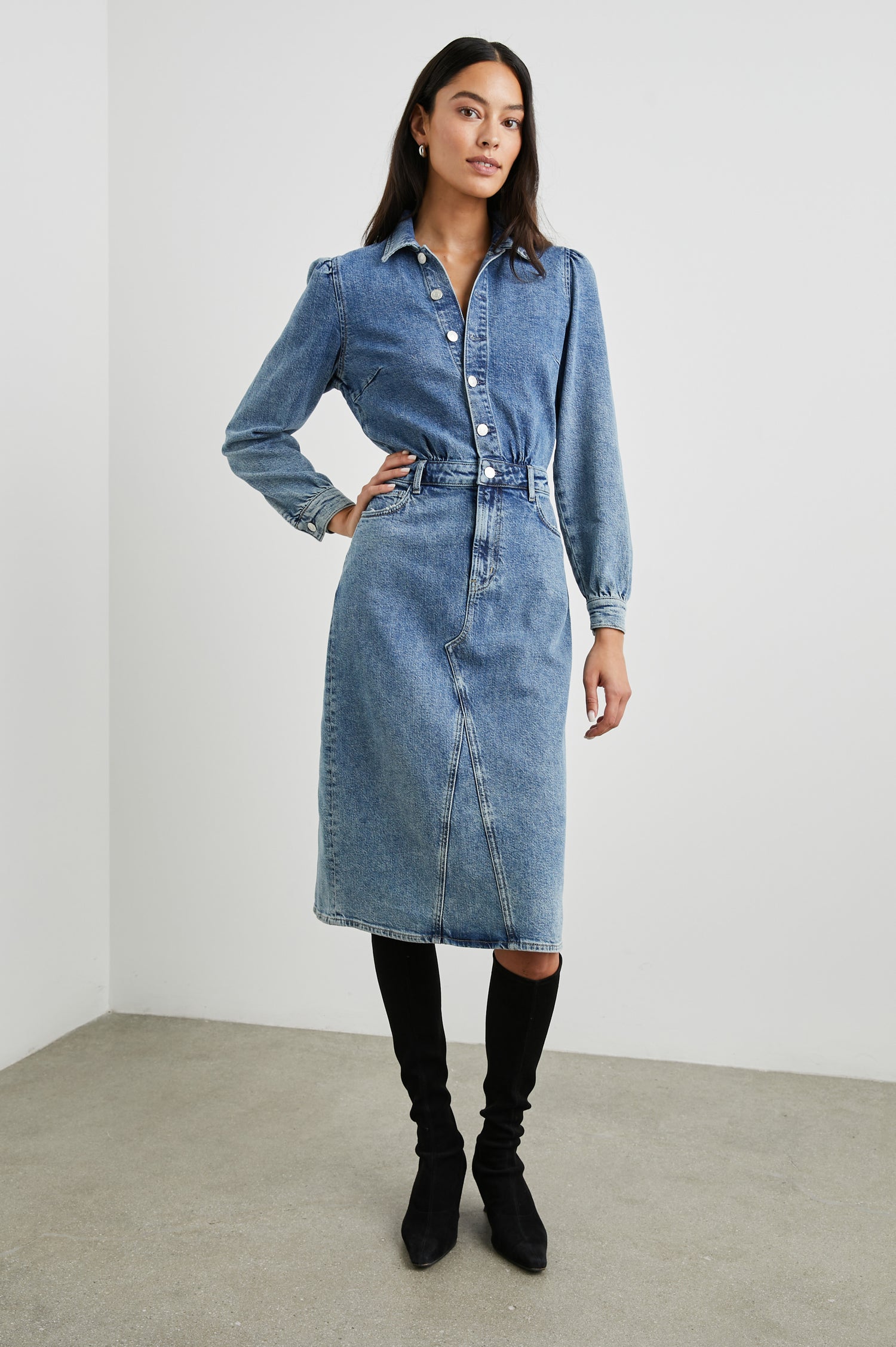 Beverly Long Sleeve Denim Knee Dress with a Back Vent, Belt Loops, a Button and Zipper Closure for the Skirt and Button Closure on the Bodice, a Collar, two Front Pockets plus a Coin Pocket and Two Back Patch Pockets in West Coast Colorway, a Blue - Front Full Body View Featured on Model