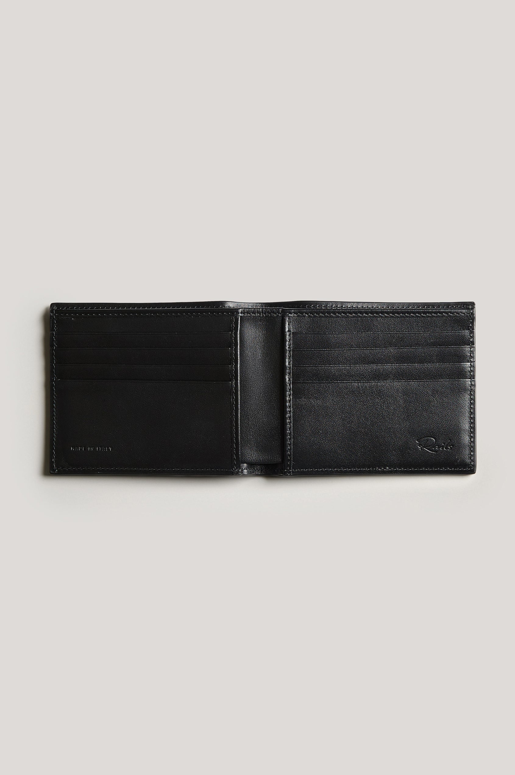 Leather wallet in black color, split open. Inside view featured.