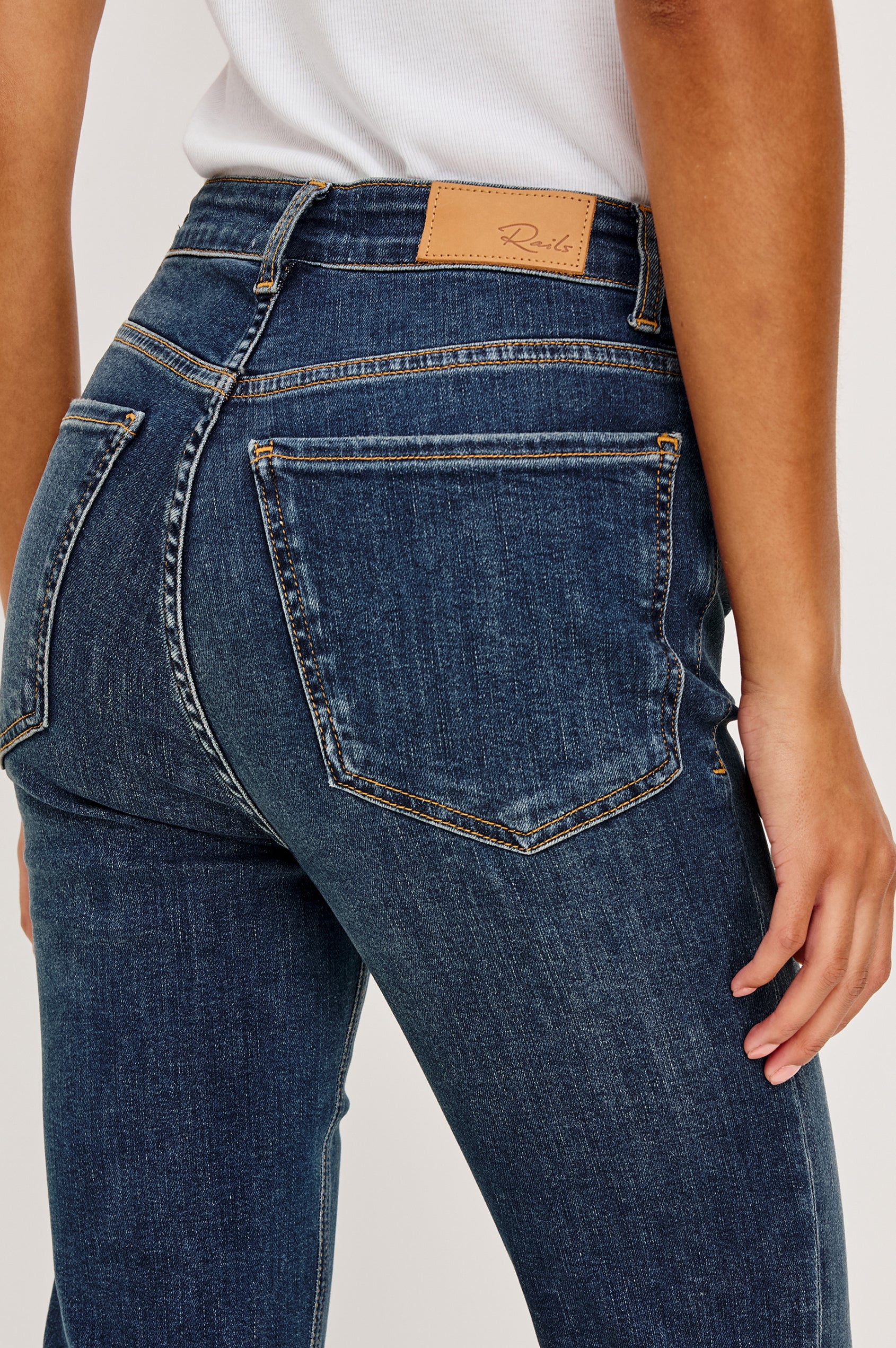 Bixby Mid-Rise Slim Straight Jean in High Stretch Denim With 28″ Inseam, Zip Fly, and 5-Pockets in Deep Dive Colorway - Lower Body Back View Featured on Model