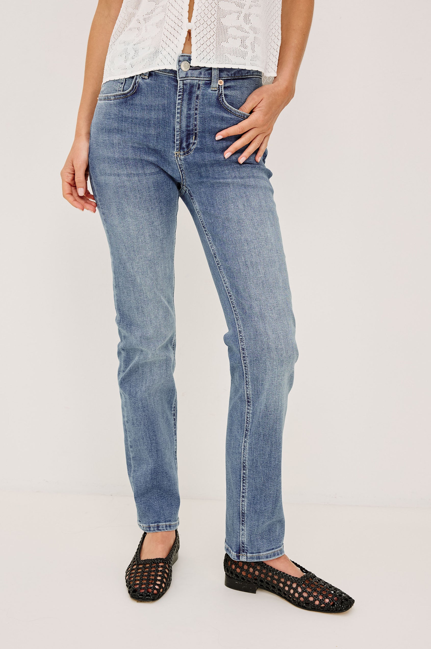 Bixby is a 5-pkt slim straight jean in Vista Blue colorway. Front view featured on model.