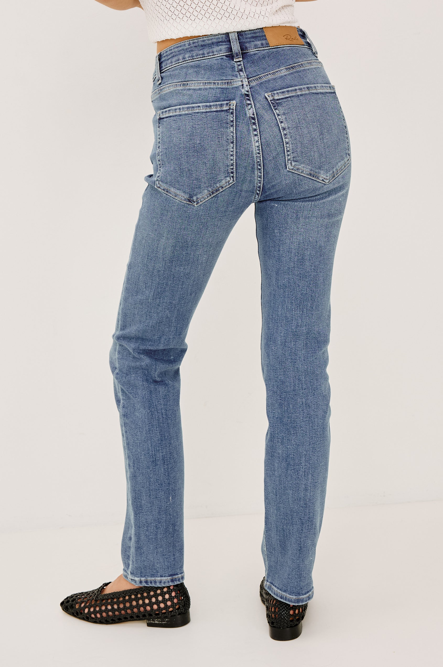 Bixby is a 5-pkt slim straight jean in Vista Blue colorway. Back view featured on model.