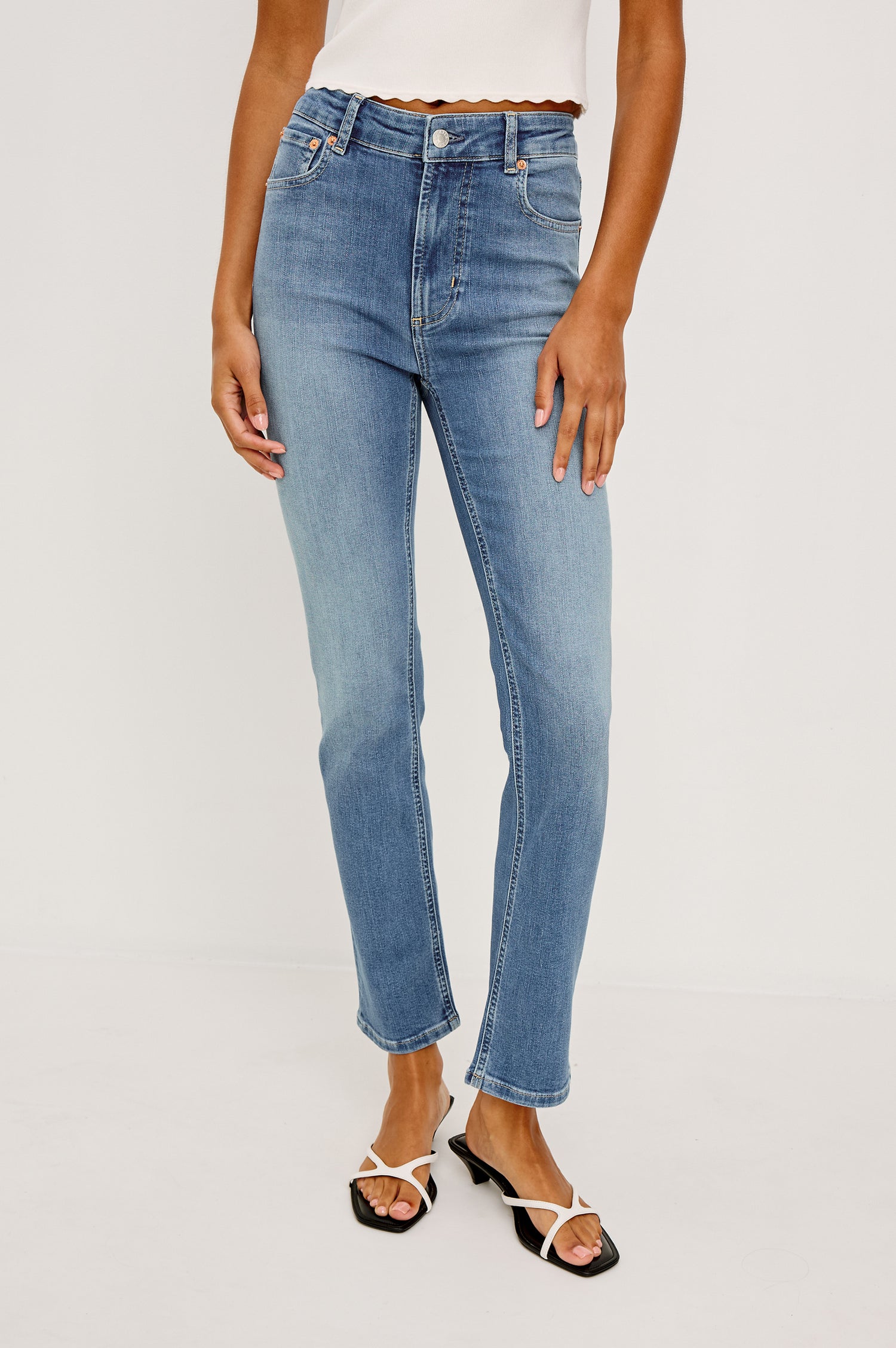 Bixby Mid-Rise Slim Straight Jean in High Stretch Denim With 25″ Inseam, Zip Fly, and 5-Pockets in Vista Blue Colorway - Lower Body Front View Featured on Model