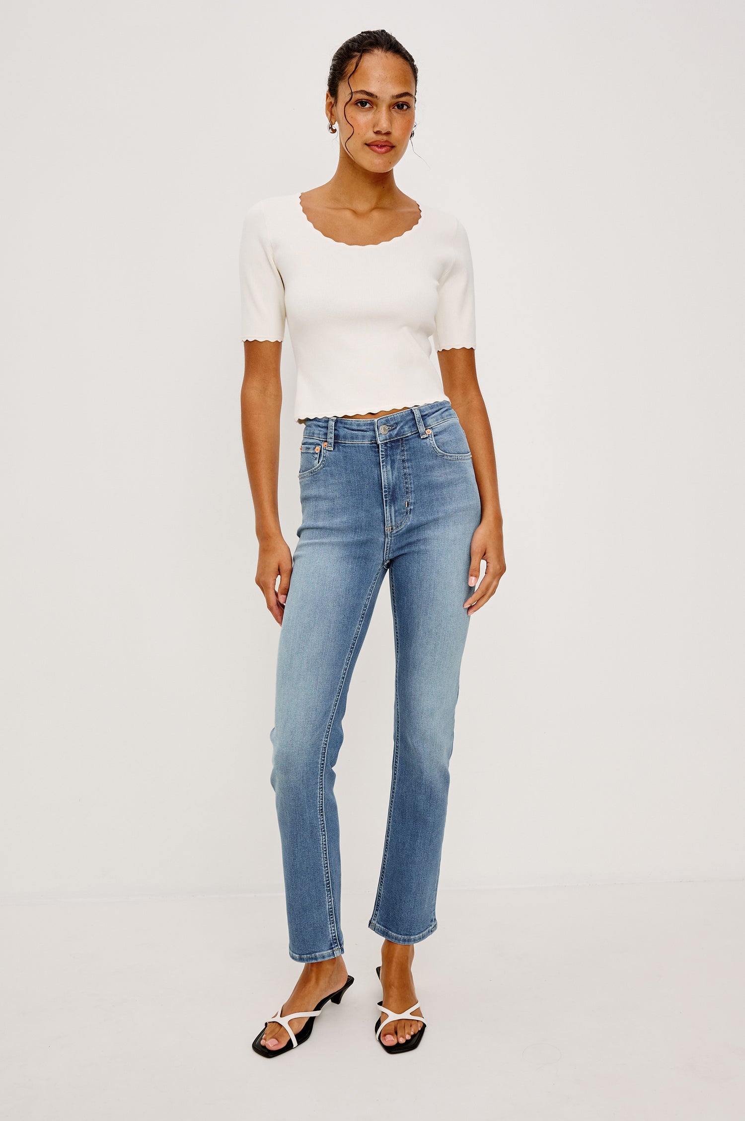 Bixby Mid-Rise Slim Straight Jean in High Stretch Denim With 25″ Inseam, Zip Fly, and 5-Pockets in Vista Blue Colorway - Lower Body Close Up Back View Featured on Model