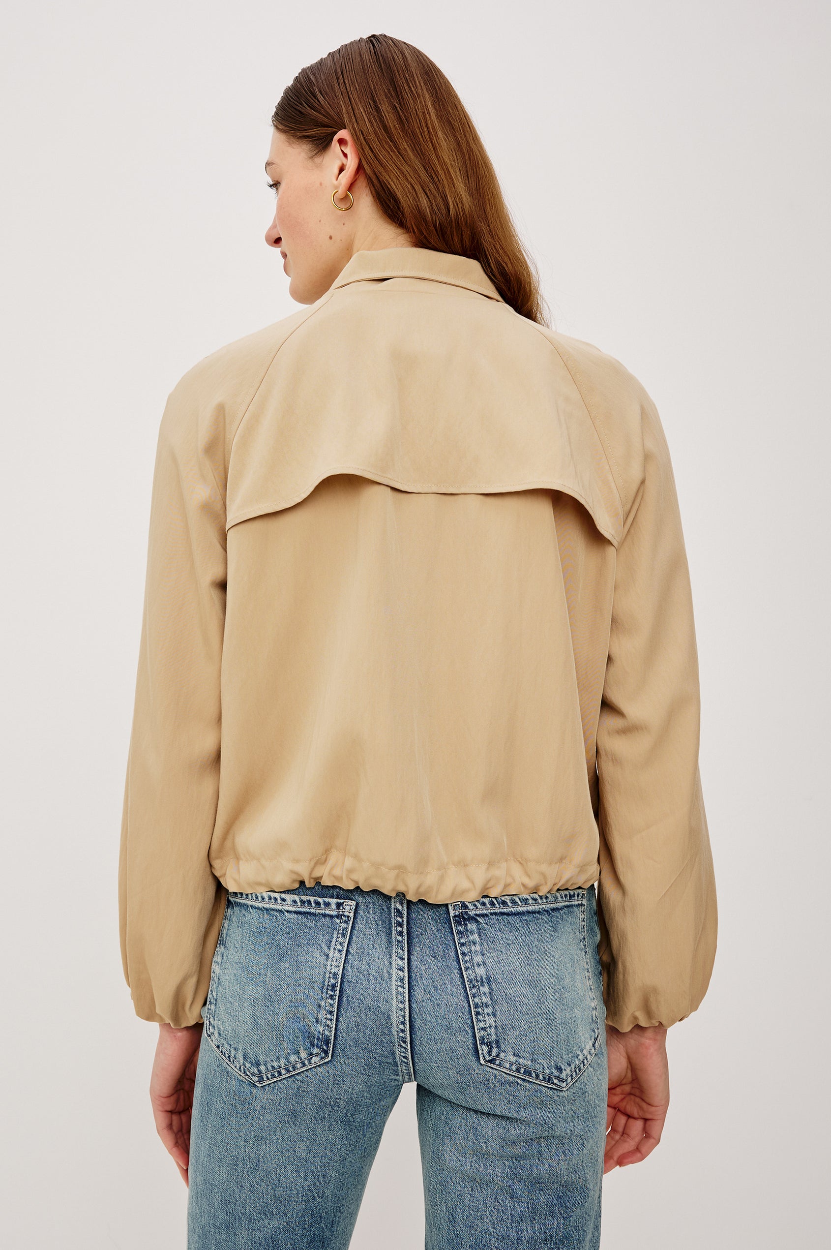 Blake Oversized Cropped Jacket With High Funnel Neck Double-Button Closures Long Drop Shoulder Sleeves With Elastic Cuffs Side Pockets and Drawstring Hem in Almond Colorway - Upper Body Back View Featured on Model