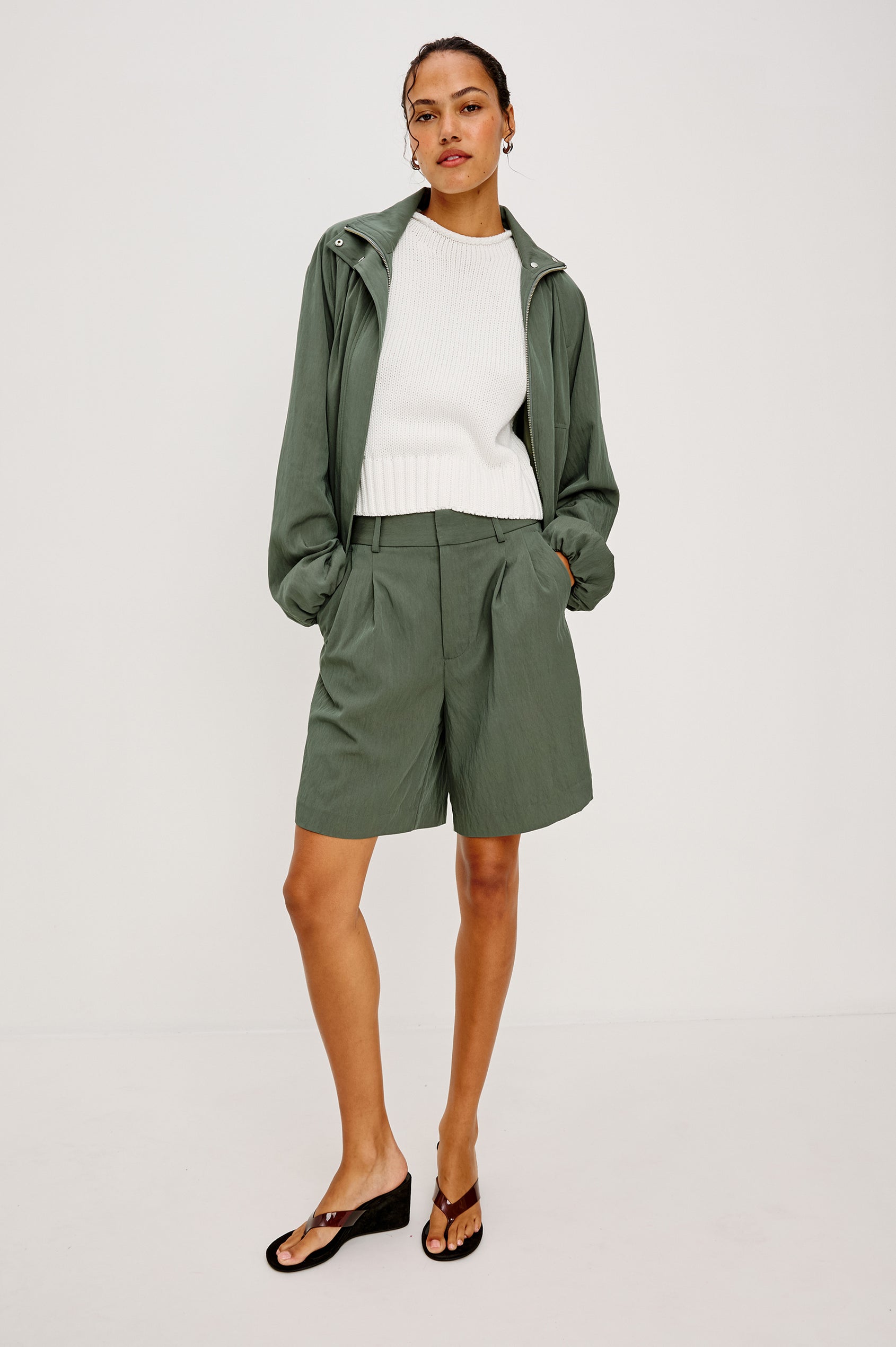 Black Jacket With Oversized Relaxed Fit High Funnel Neck Dropped Shoulders Long Sleeves Center-Front Ties Side-Seam Zipper in Ivy Colorway - Upper Body Front View Featured on Model