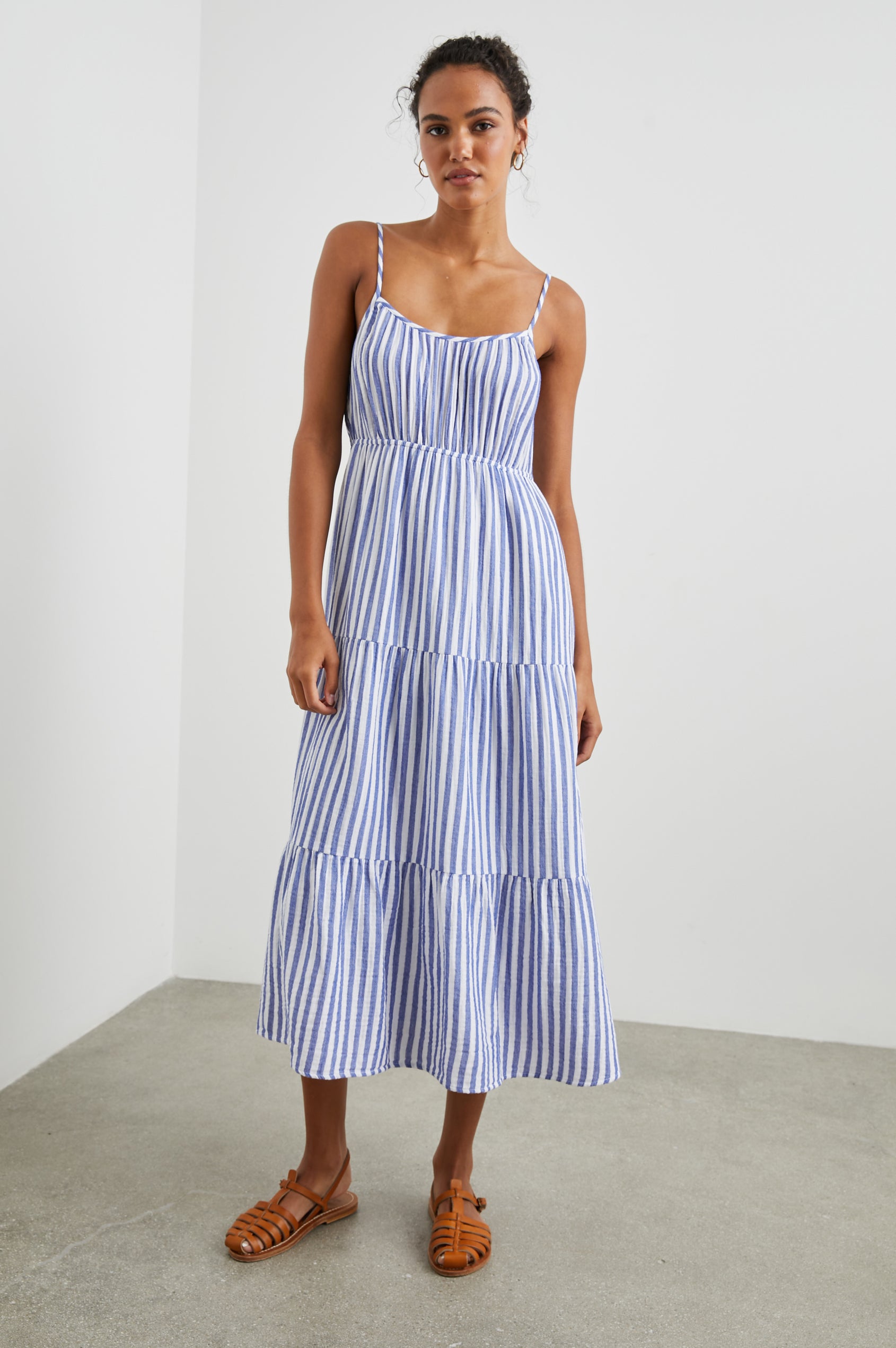 Blakely Sleeveless Tiered Midi Dress with Adjustable Spaghetti Straps and a Scoop Neck in Anacapa Stripe Colorway, Blue and White Vertical Stripes - Front Full Body View Featured on Model 