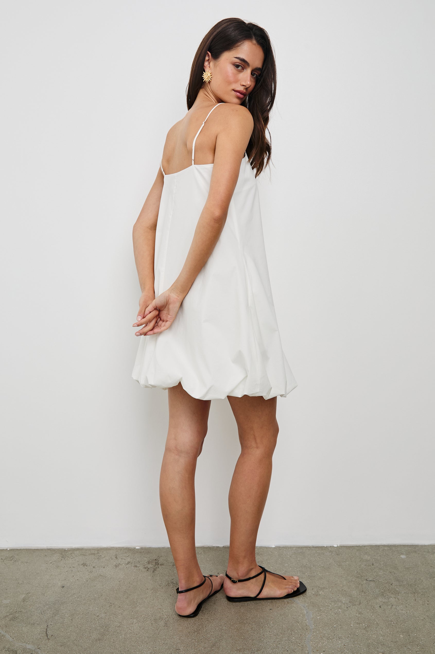 Bianca Mini Tank Dress with Spaghetti Straps, Side Pockets and a Bubble Hem in White Colorway. Full Body Back View Shown on Model.