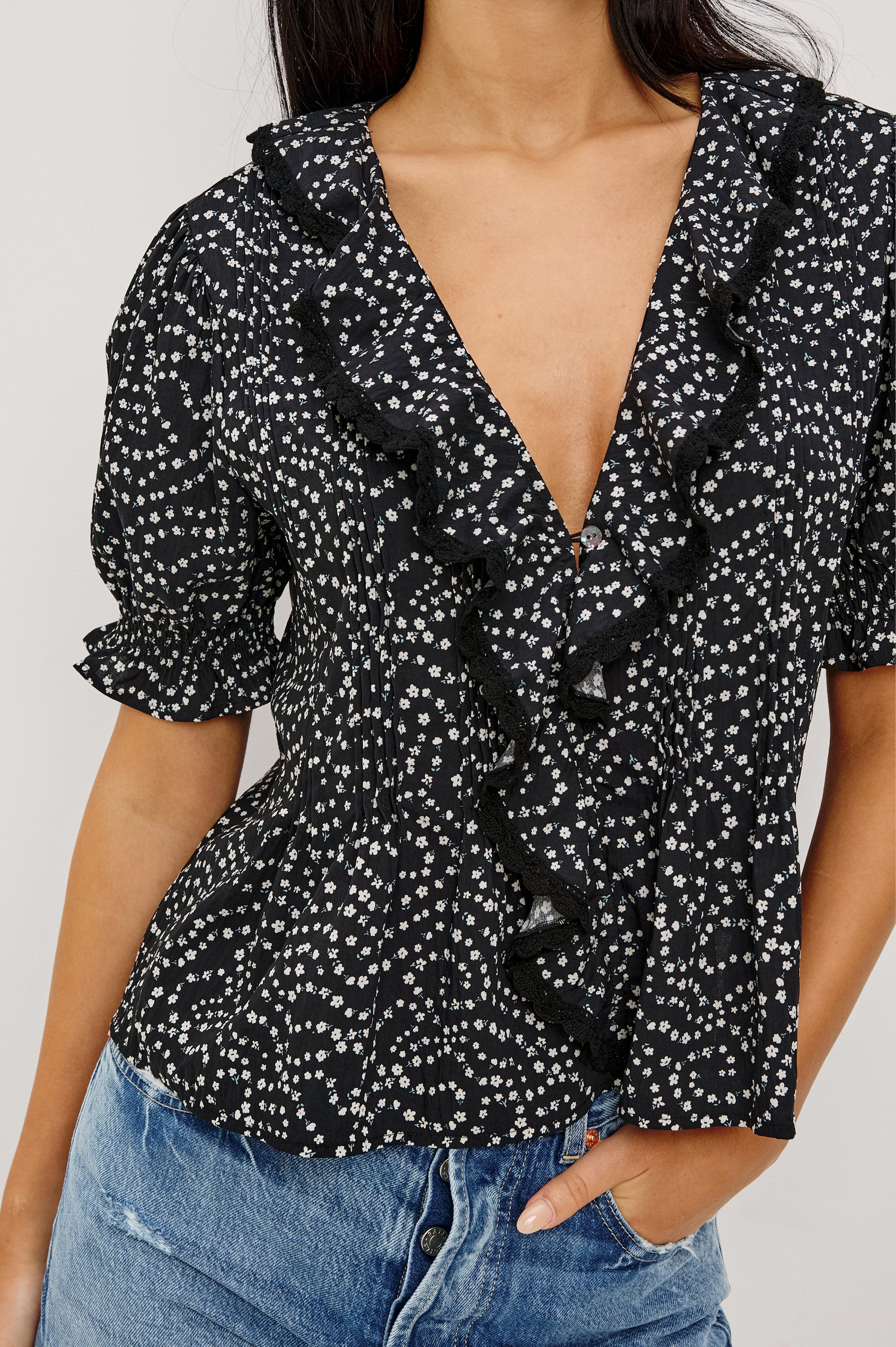 Bloom Poplin Top With Ruffle V-Neckline, Elbow-Length Puff Sleeves With Ruffled Cuffs, Pintuck Detailing, and Boxy Relaxed Fit in Mini Chain Daisies Colorway - Upper Body Front View Featured on Model