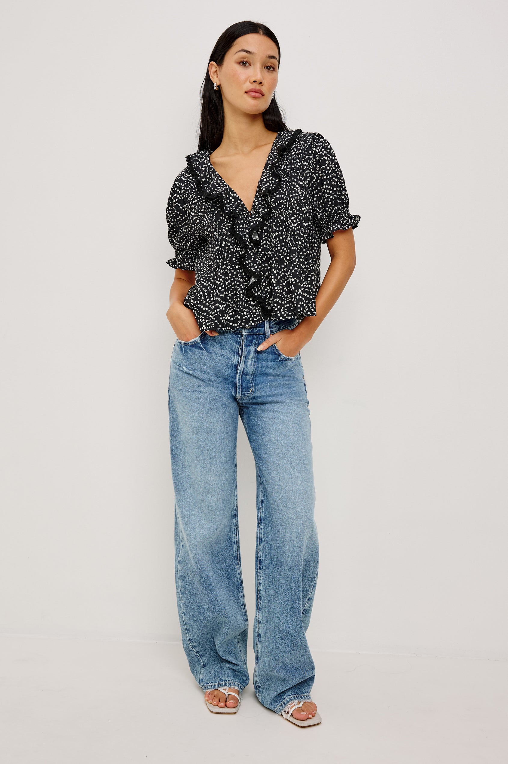 Bloom Poplin Top With Ruffle V-Neckline, Elbow-Length Puff Sleeves With Ruffled Cuffs, Pintuck Detailing, and Boxy Relaxed Fit in Mini Chain Daisies Colorway - Full Body Front View Featured on Model