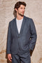 The Bond is a single breasted blazer with two buttons, one chest pocket and two patch pockets in a blue Meridian colorway. Front view featured on model.