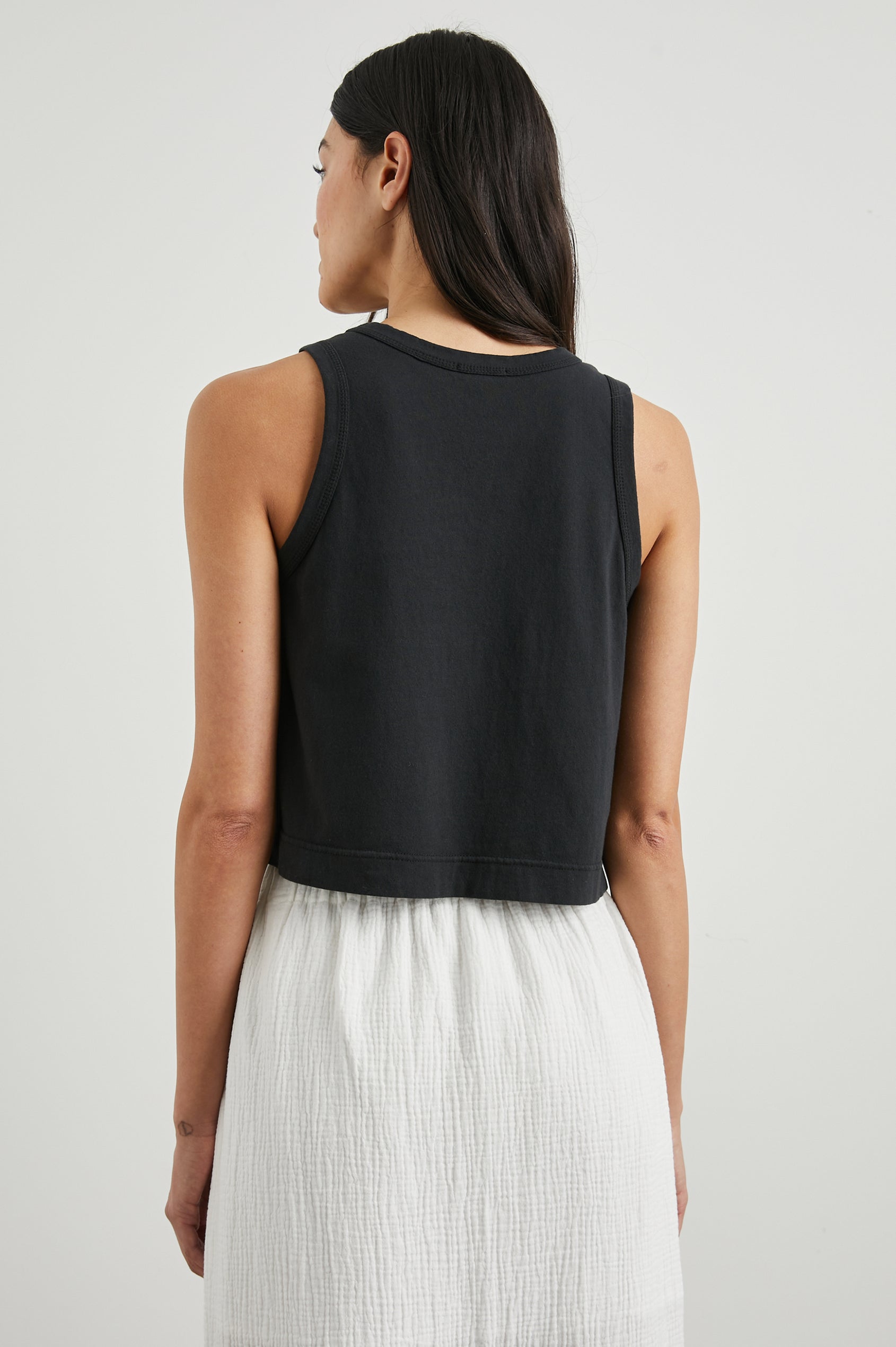 The Boxy Cropped Tank with a Crew Neck in Black Colorway - Back View Featured on Model