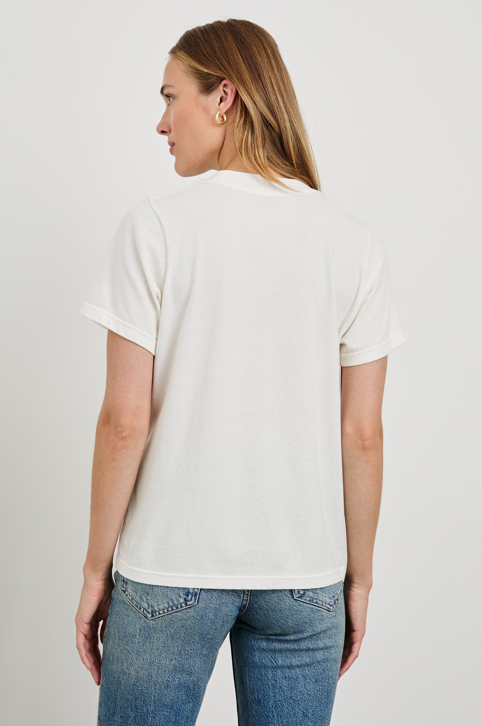 Boyfriend T-Shirt with a Crew Neck, an image of Los Angeles sites and objects, and the text, Rails Los Angeles in Rails Los Angeles Map White Colorway, with text and image in yellow, pink, blue and tan - Back View Featured on Model