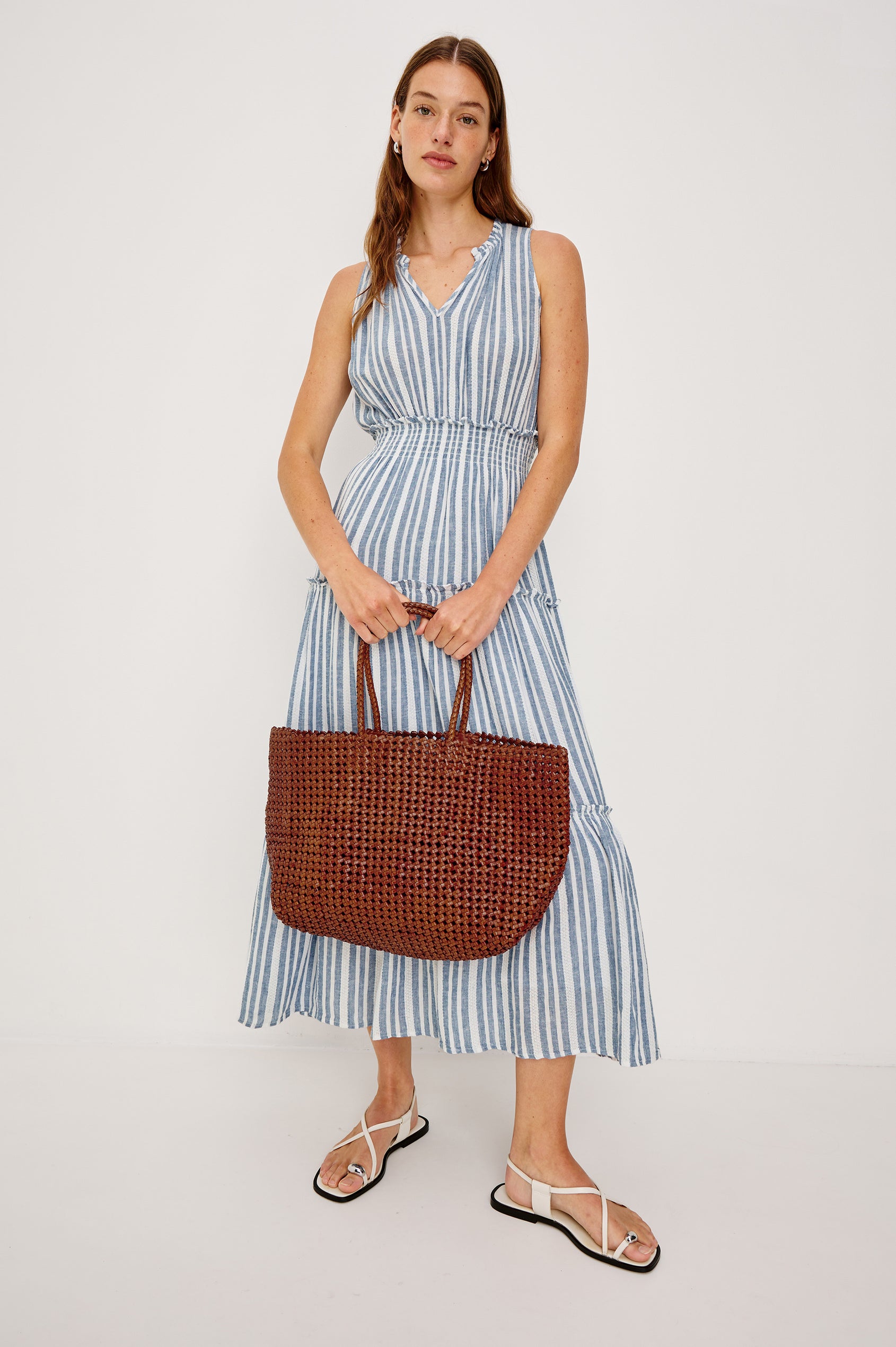 Brava oversized woven tote bag in Cognac brown - full body view of model holding bag at front