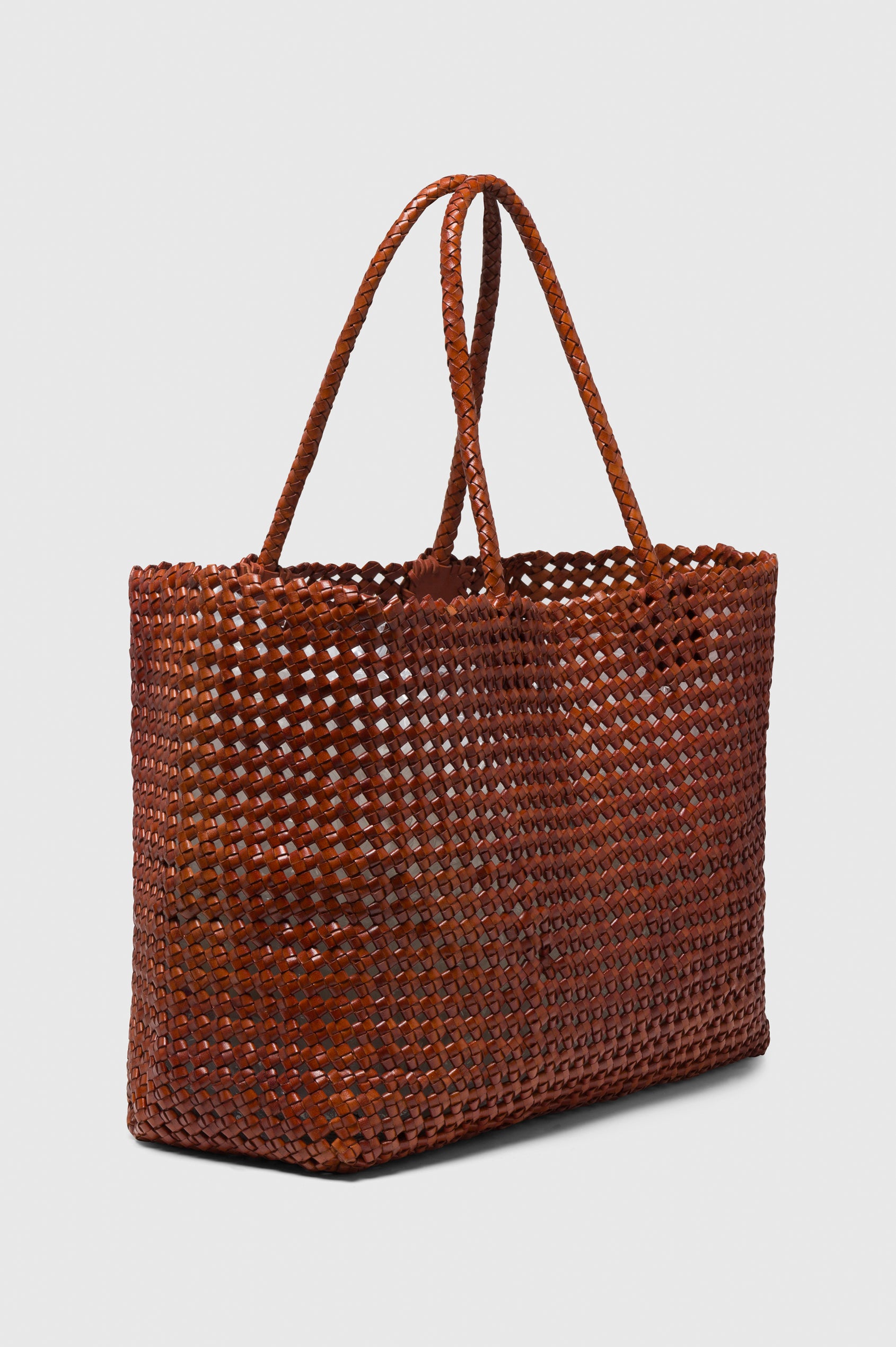 Brava oversized woven tote bag in Cognac brown - side view of bag
