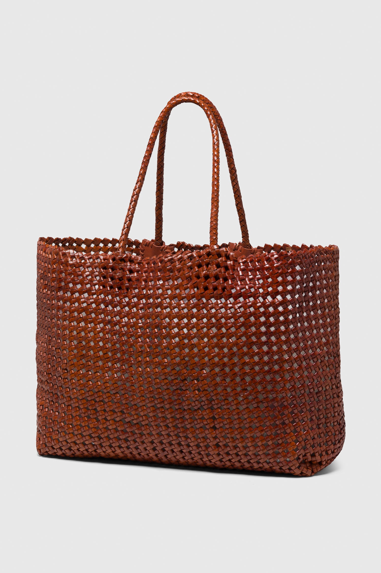 Brava Tote in Woven Leather With Top Handles and Spacious Interior in Cognac Colorway - angeled view off model