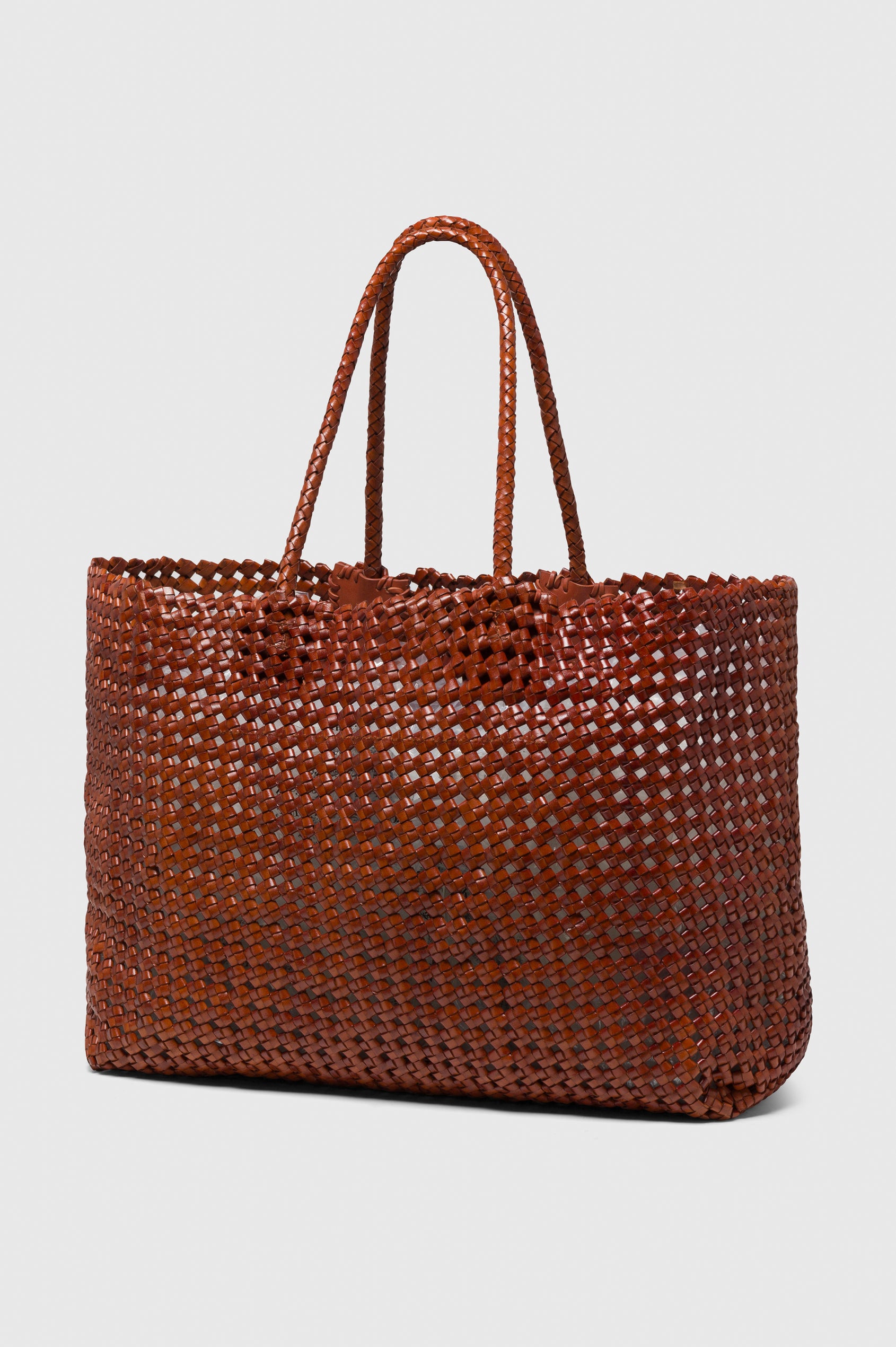 Brava Tote in Woven Leather With Top Handles and Spacious Interior in Cognac Colorway - angeled view off model