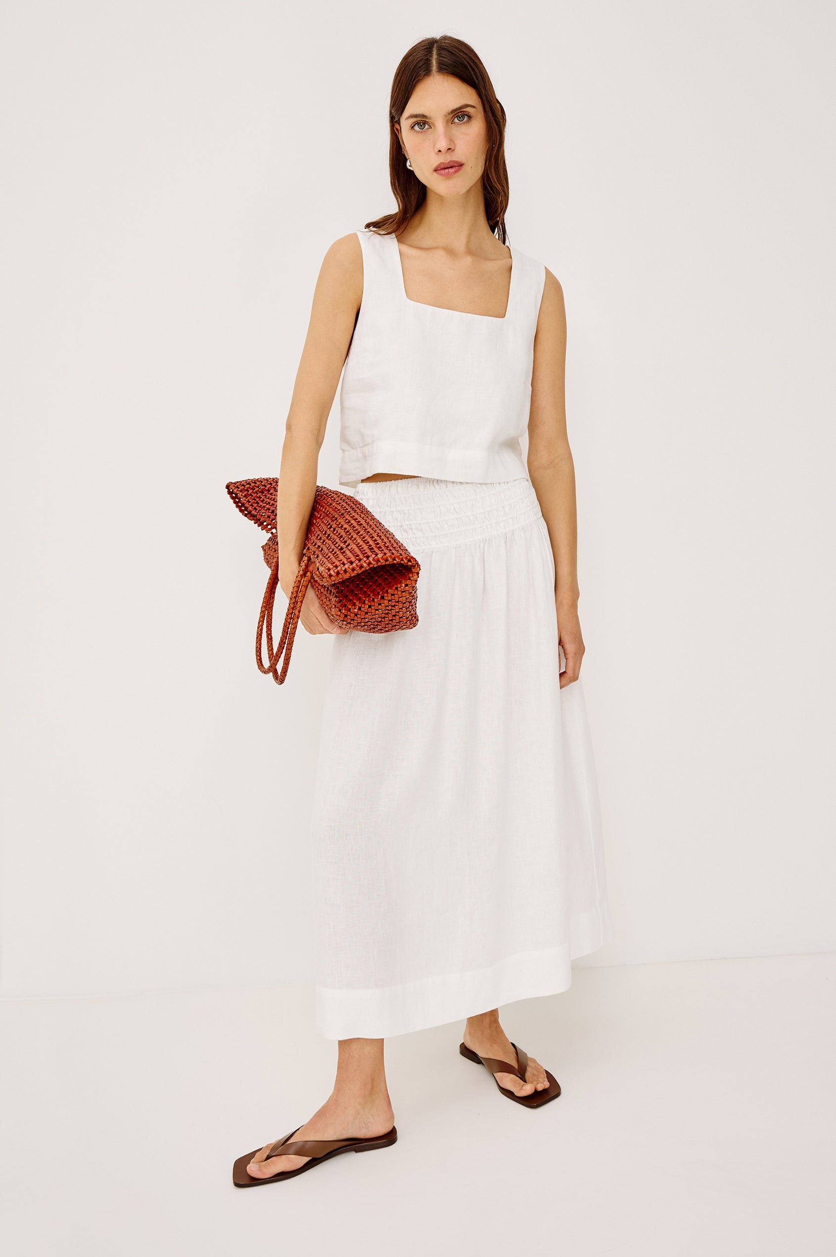 Brava oversized woven tote bag in Cognac brown - full body view of model holding bag in hand