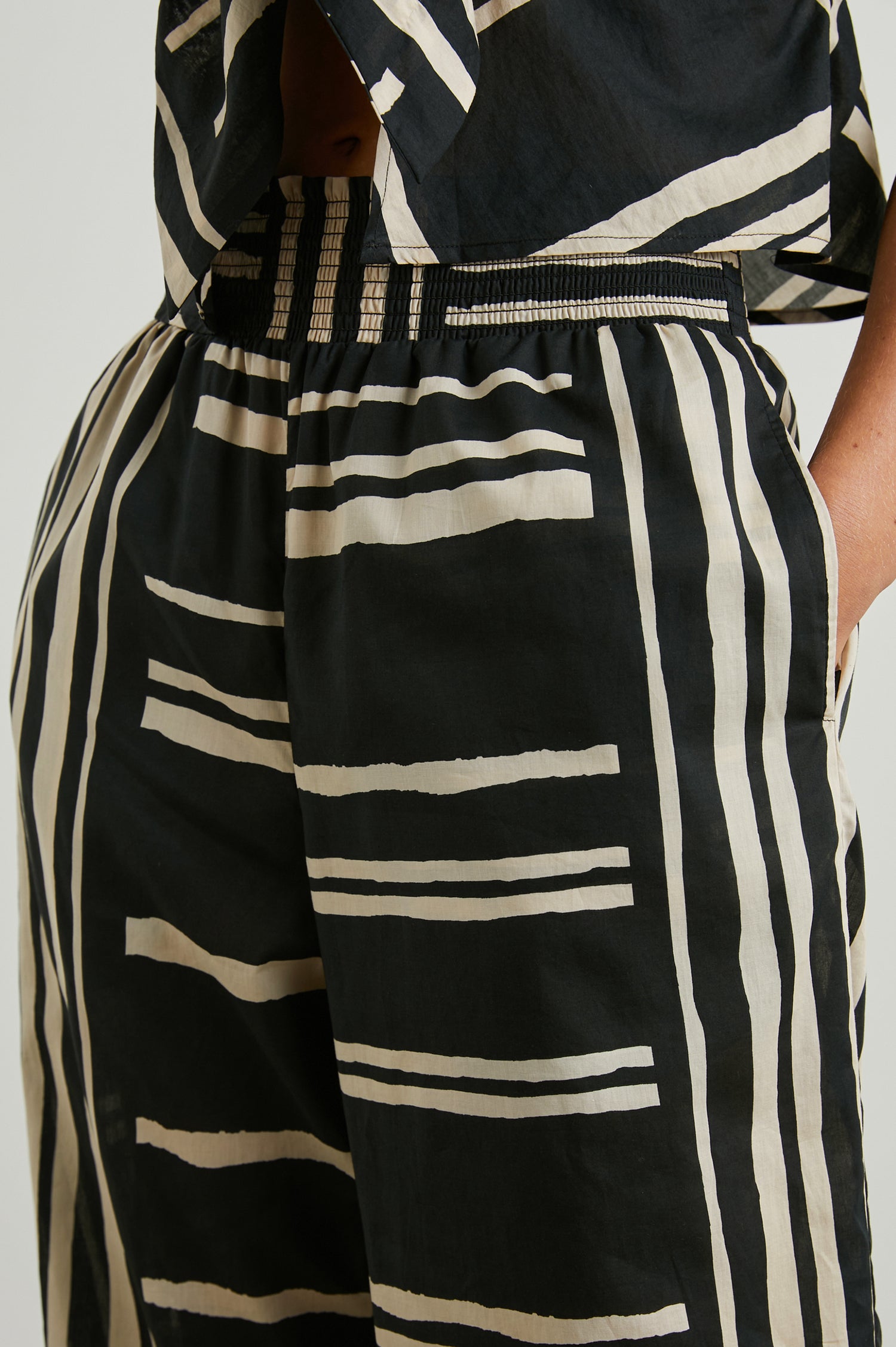 Brendon high-rise Pant with Elastic Waist and two front pockets in Island Stripe Colorway, with white vertical and horizontal stripes on black - Front View Featured on Model