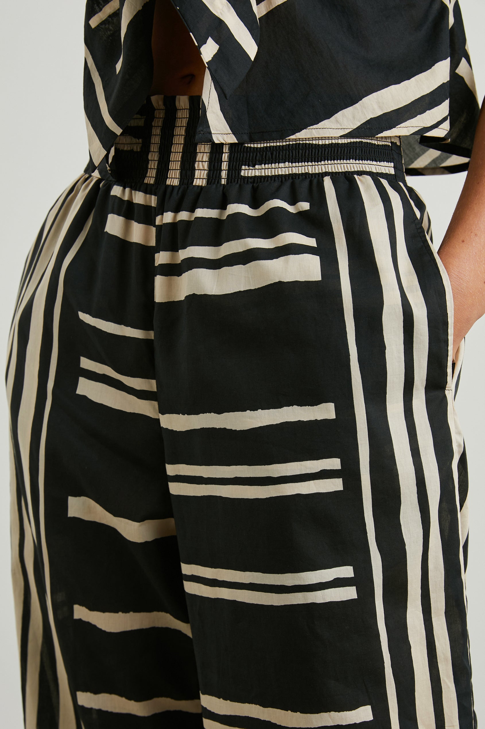 Brendon high-rise Pant with Elastic Waist and two front pockets in Island Stripe Colorway, with white vertical and horizontal stripes on black - Front View Featured on Model