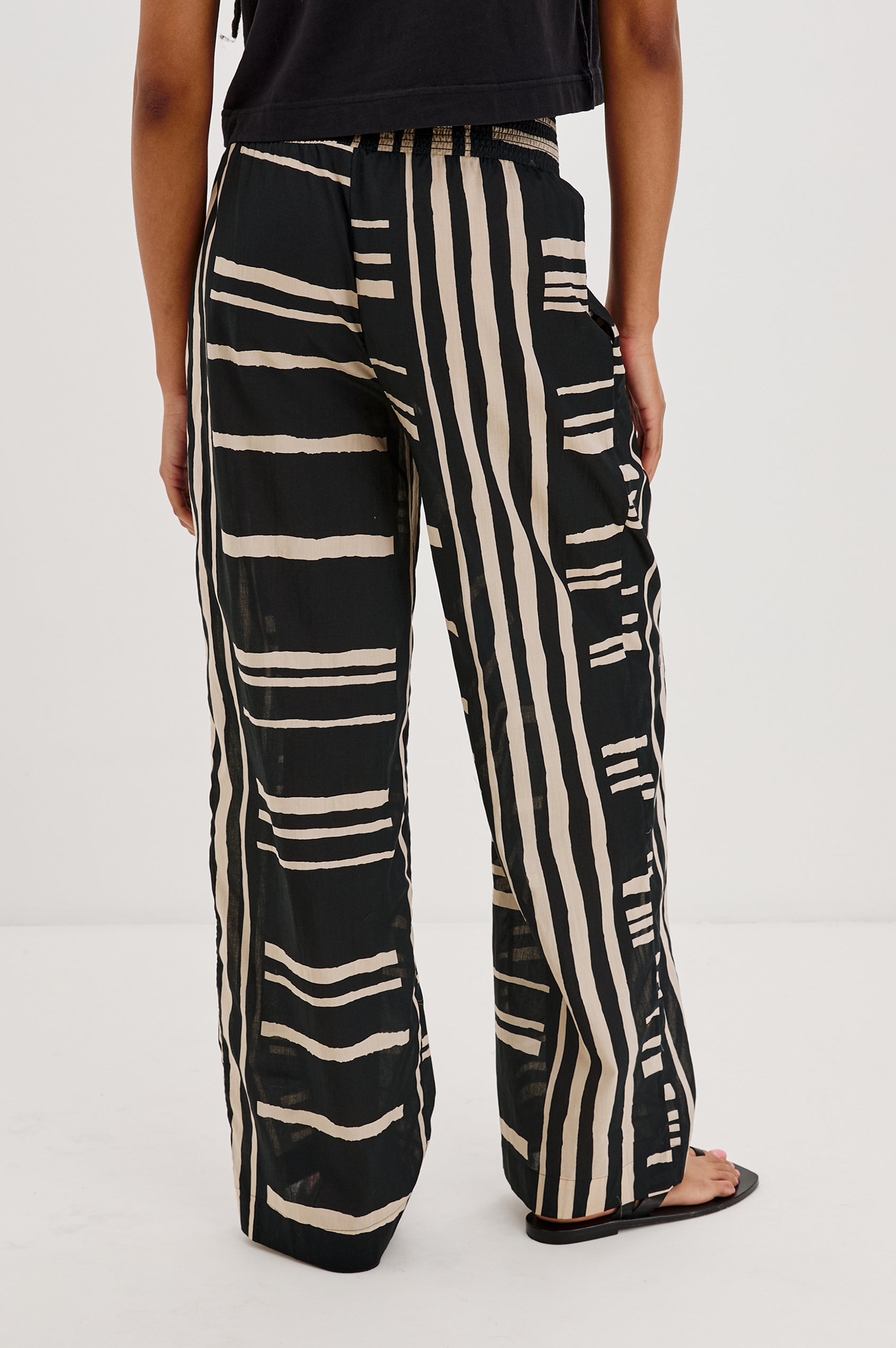 Brendon high-rise Pant with Elastic Waist and two front pockets in Island Stripe Colorway, with white vertical and horizontal stripes on black - Back View Featured on Model