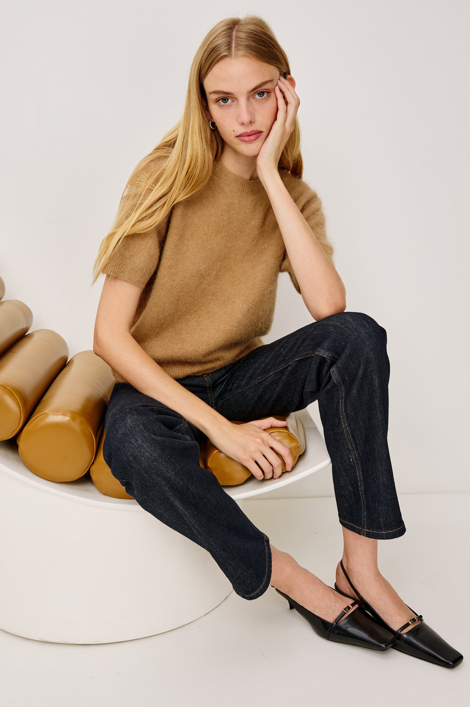 Briar Short-Sleeve Top with a Crew Neck and Ribbed Trim in Camel Colorway - Stylized Front View Featured on Model Sitting Down