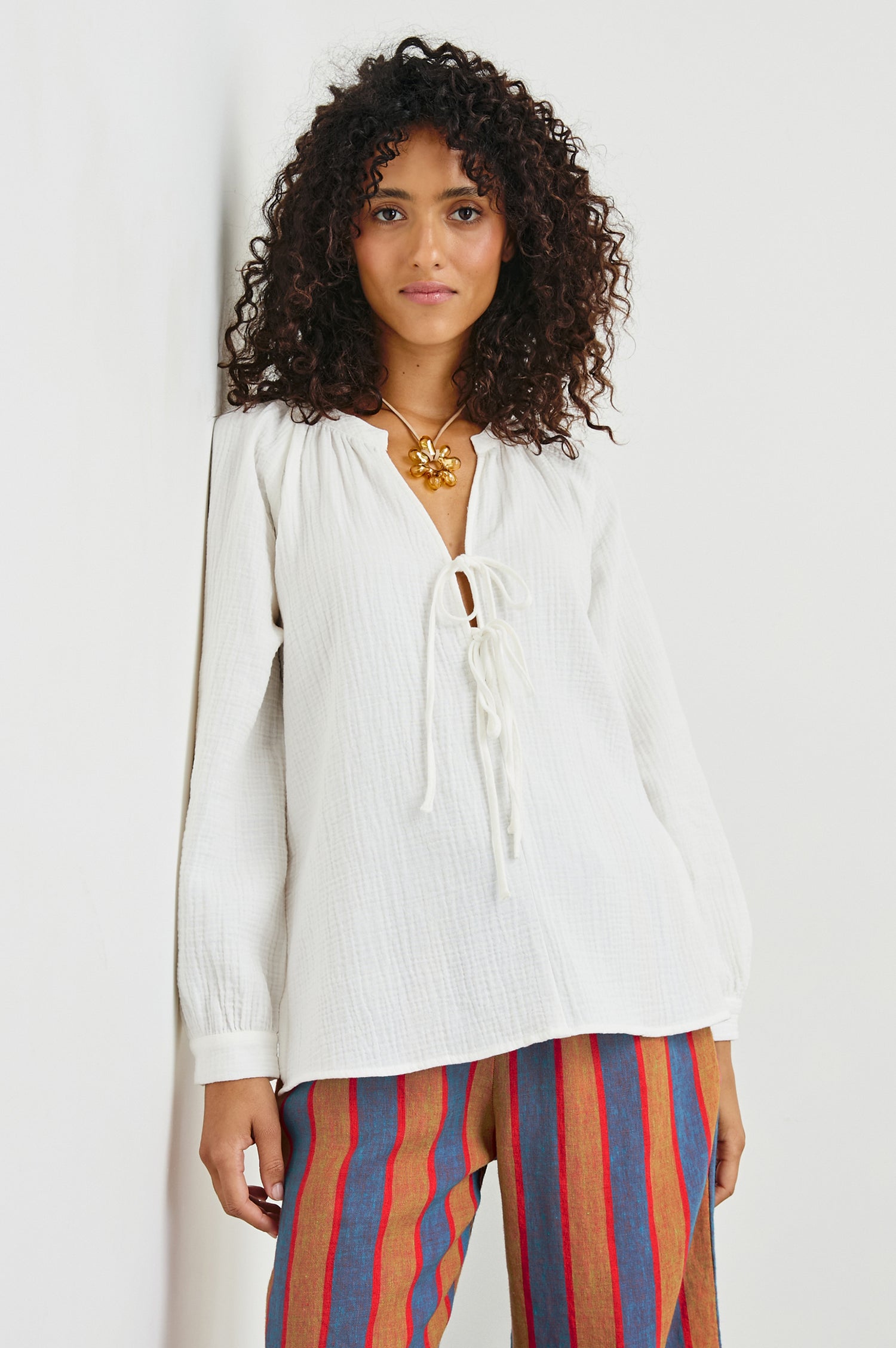 Brielle white short-sleeve top featuring eyelet embroidery and puffed sleeves - front view featuring on model.