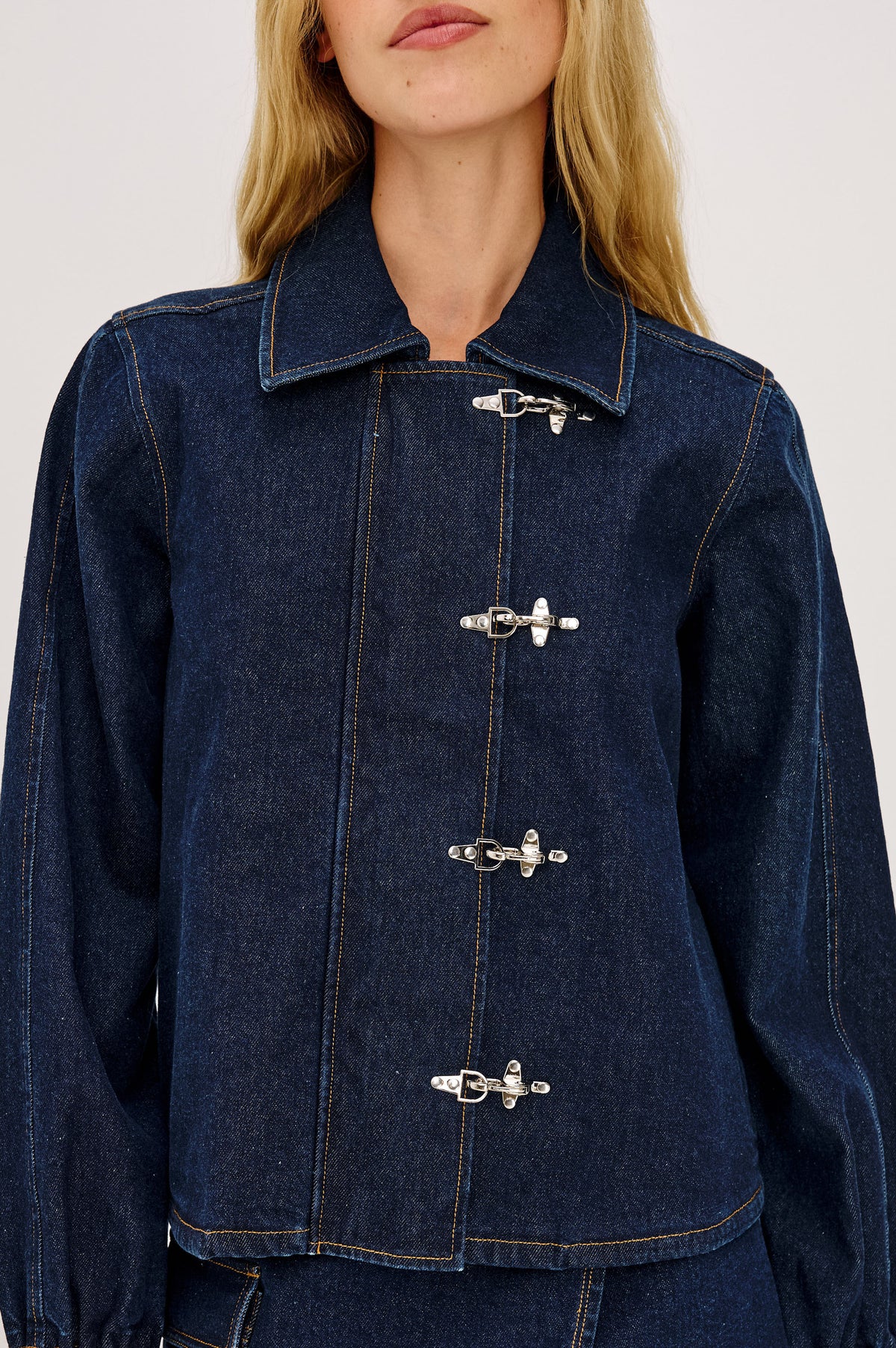 Brooke Jacket in Midweight Denim With Duffel Slightly Cropped Fit, Long Balloon Sleeves, Elastic Cuffs, Back Yoke Pleat, and Front Toggle Closures in Rinse Indigo Colorway - Upper Body Front View Featured on Model