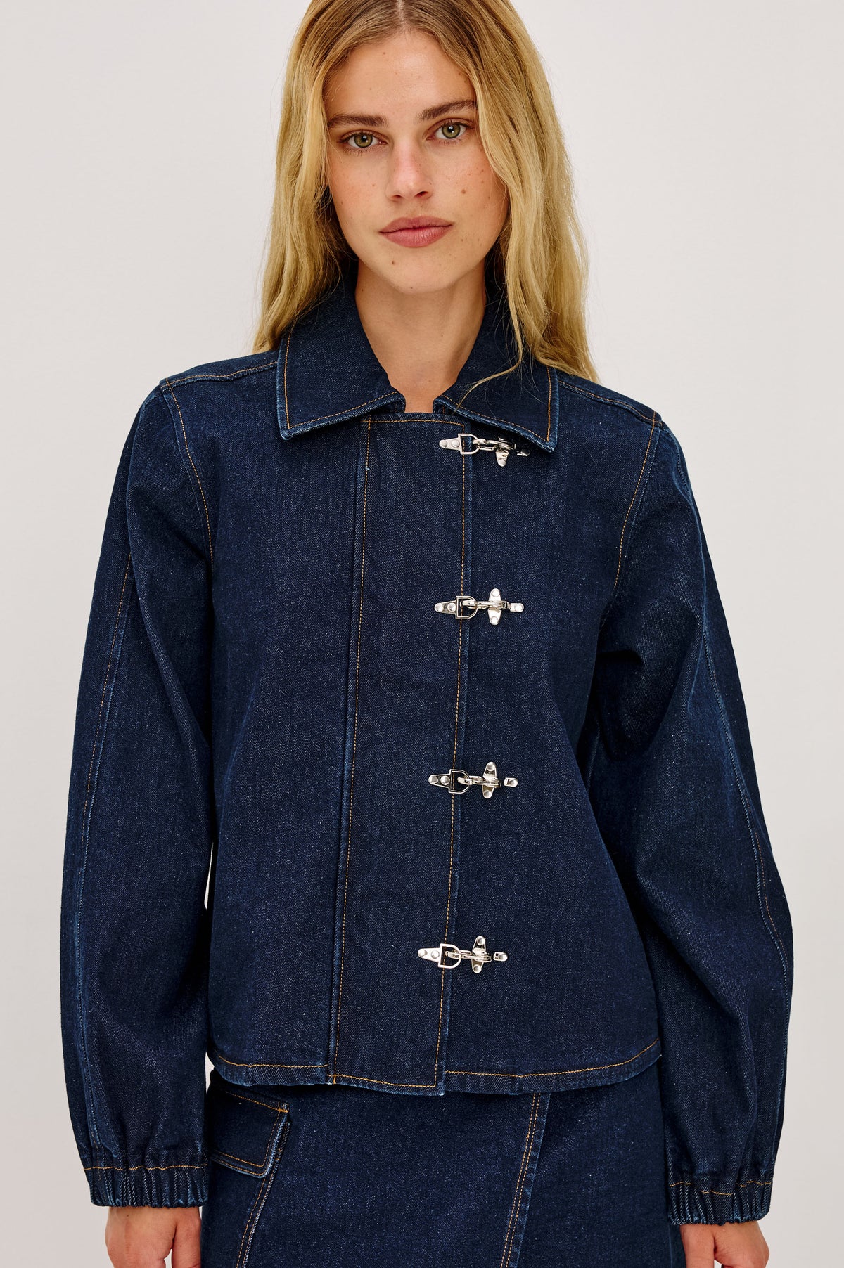 Brooke Jacket in Midweight Denim With Duffel Slightly Cropped Fit, Long Balloon Sleeves, Elastic Cuffs, Back Yoke Pleat, and Front Toggle Closures in Rinse Indigo Colorway - Upper Body Front View Featured on Model