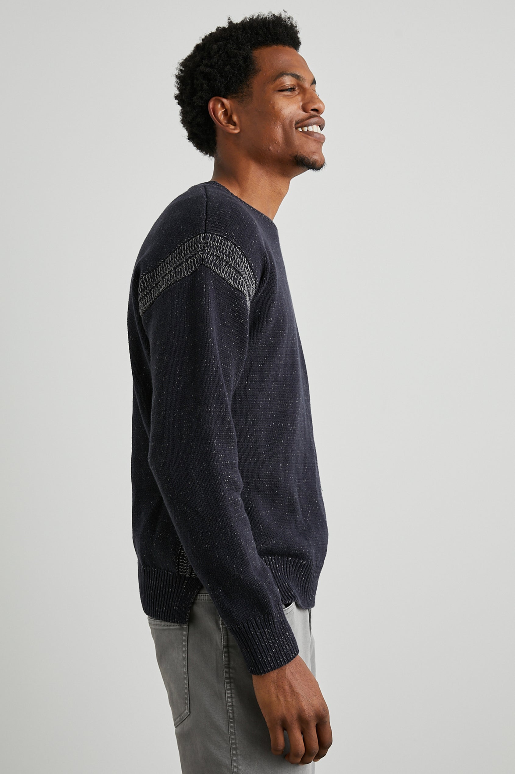 Bryce Long-Sleeve Sweater with a Crew Neck, Ribbed Trim in Navy Colorway, with White Speckles and Stitching at Shoulder Seams - Side View Featured on Model 