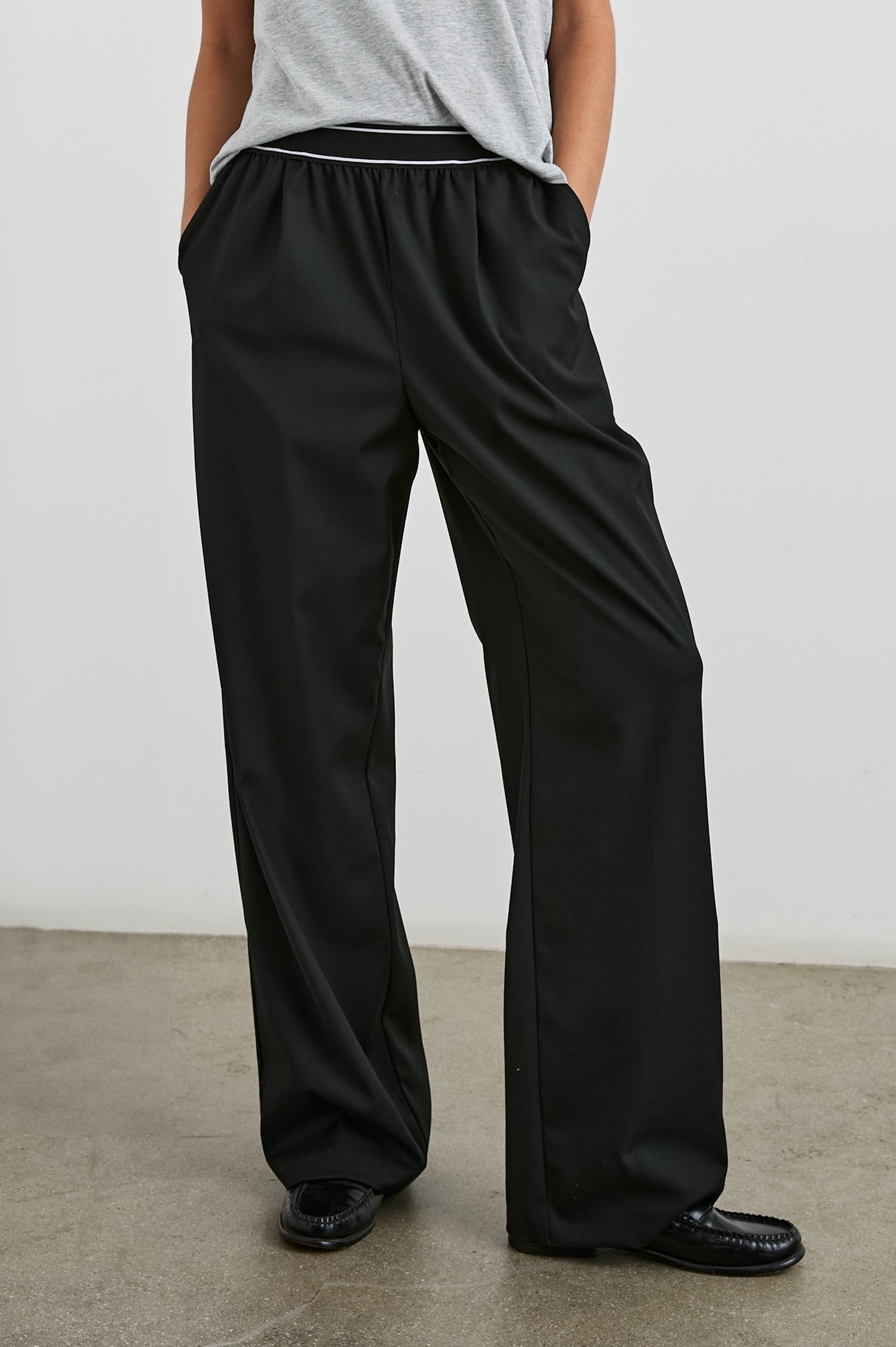 Brynn Pants with Two Front Pockets and Elastic Waist Band with White Trim in Black Colorway - Front View Featured on Model
