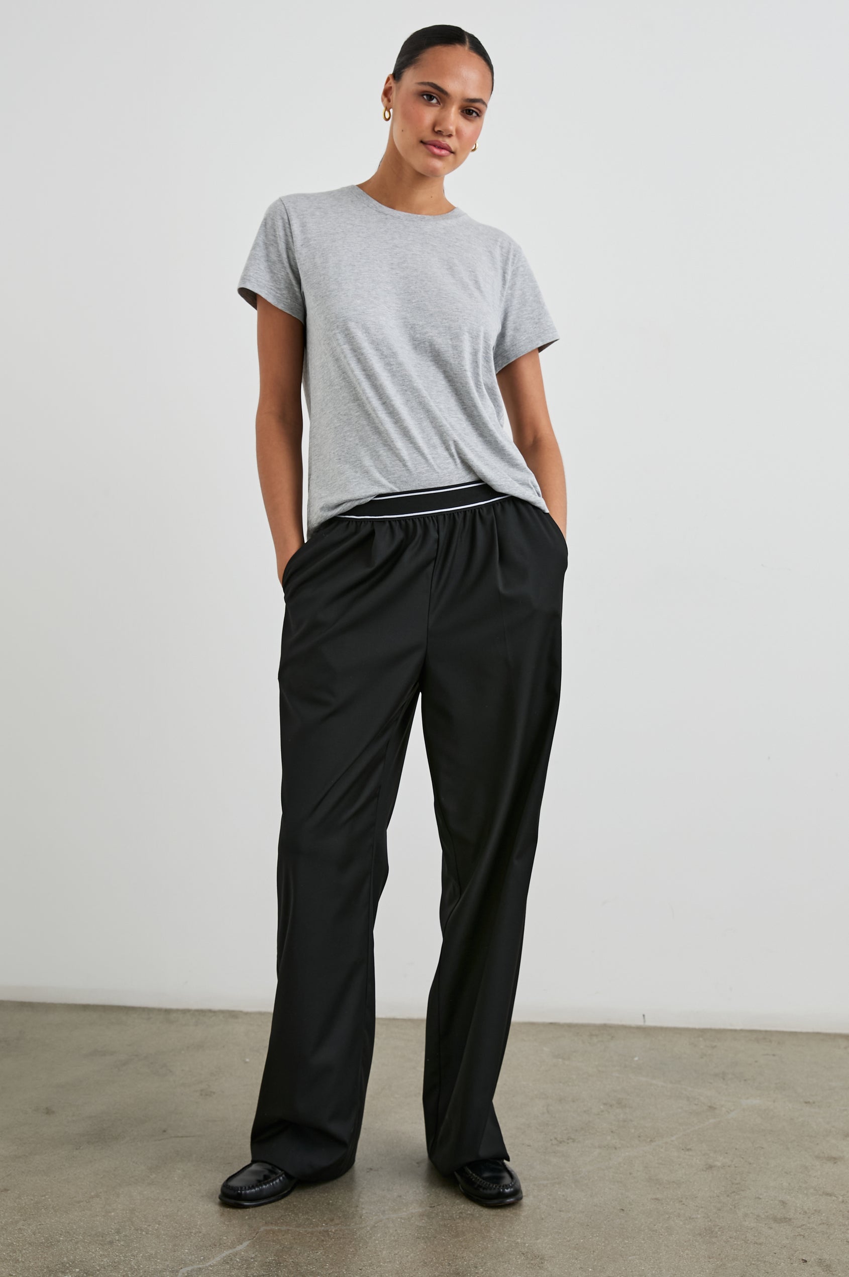 Brynn Pants with Two Front Pockets and Elastic Waist Band with White Trim in Black Colorway - Front Full Body View Featured on Model