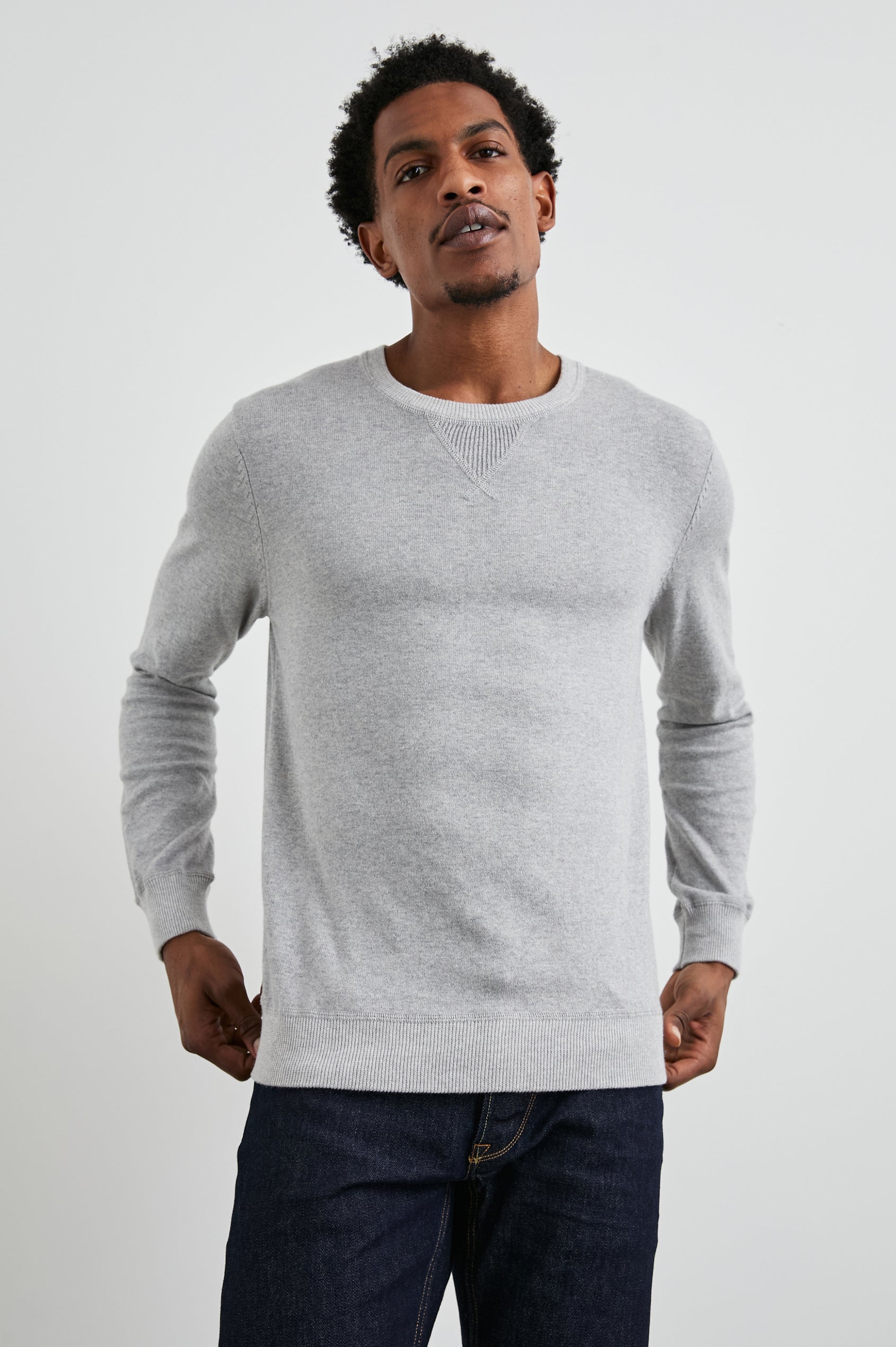 Burns Long-Sleeve Sweater with a Crew Collar and a Lighter Colored Ribbed Trim in Grey Heather Colorway - Front View Featured on Model