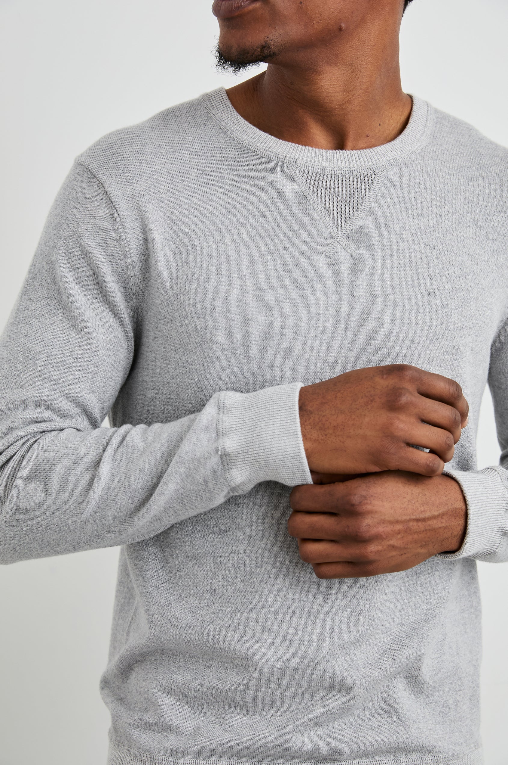 Burns Long-Sleeve Sweater with a Crew Collar and a Lighter Colored Ribbed Trim in Grey Heather Colorway - Front View Featured on Model