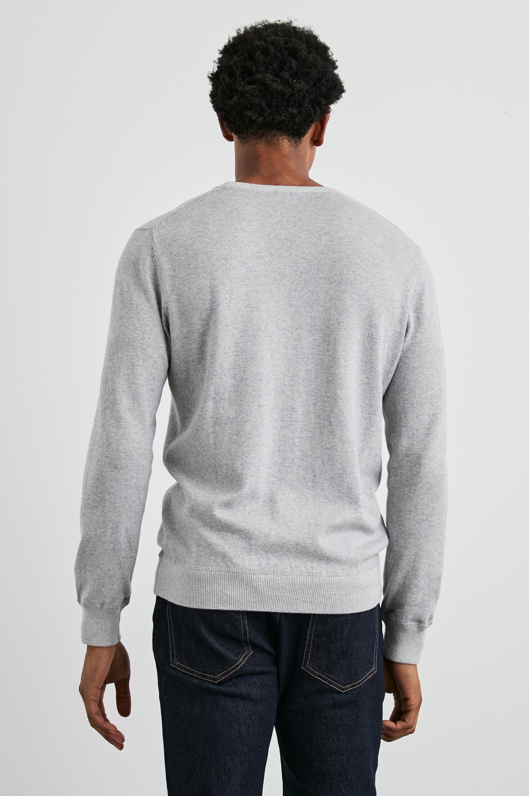 Burns Long-Sleeve Sweater with a Crew Collar and a Lighter Colored Ribbed Trim in Grey Heather Colorway - Back View Featured on Model