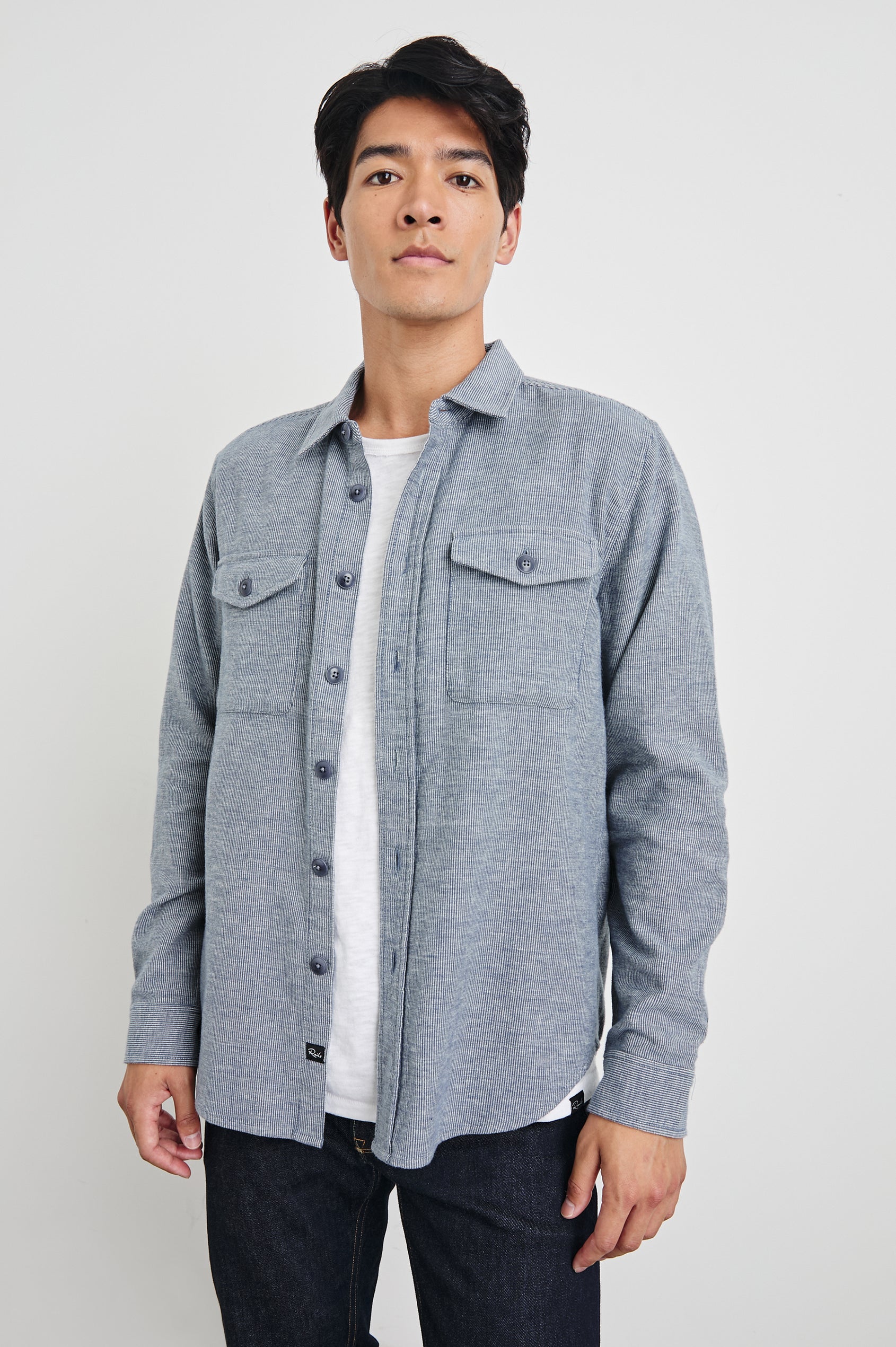 Burr Collared Shirt Jacket with Button Closure, Two Chest Button Flap Pockets and Textured Fabric in Denim White Colorway - Front Unbuttoned View Featured on Model